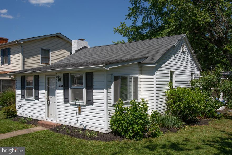 2 Bedroom/1.5 Bathrooms. Here is the one for you!  Perfect cottage waiting for you and your decorations to make it your own beach get away!  .  Upon entry, nice sun room porch area for extra guests or sitting room with view of River.  The main living area has hardwood flooring throughout living  and bedrooms with  fireplace and area for dining.  Come make it your own!  This cottage is tucked away on 5th Street  and Laura Lane, with fully fenced rear yard with shed and screened in porch on two sides. and plenty of privacy.  Roof and Windows recently upgraded.  Just steps from the sandy beach on the Potomac River.  Golf Cart Community with Community Boat launch ramp and dock on 8th Street. Restaurants and Marina, groceries all in the Community.