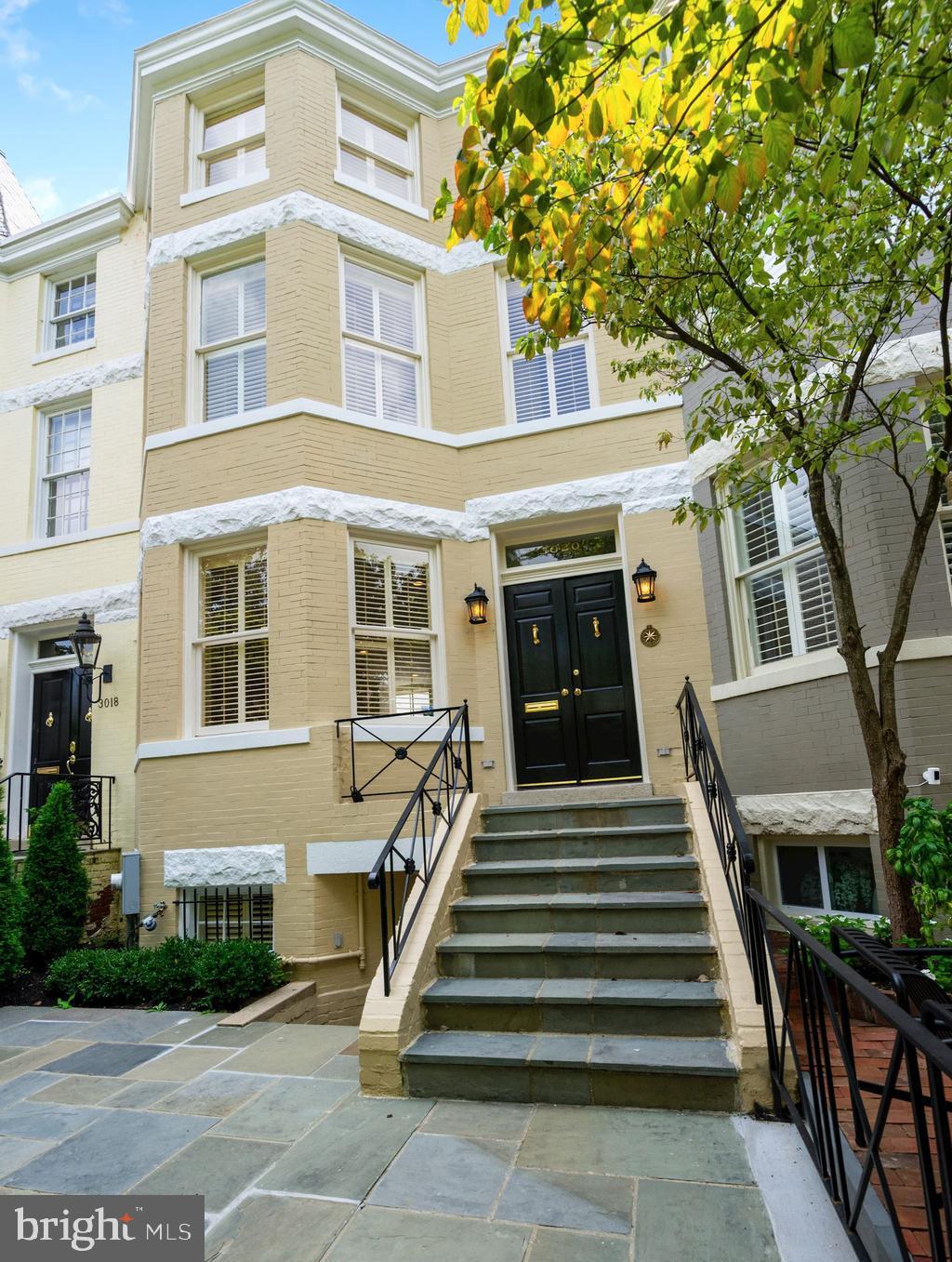 PRICE ADJUSTMENT! Large and wide, fully restored townhouse with 2 CAR PARKING and lower level suite with separate entrance perfect for home office/ gym, playroom or nanny . Renovation/restoration of both interior and exterior just finished in June 2020 including a new heating system, a new AC and new water heater. The First Floor design is open and gallery-like with 9+ foot ceilings and a double living room with antique pine wood floor, atrium windows, fireplace, and gourmet kitchen with custom cabinetry and granite counters. The Upper Level boasts an owner's suite with 13-foot ceilings and large walk-in closet plus two additional bedrooms each with ensuite bathrooms, all featuring great natural light. The Lower Level offers a complete au-pair suite (or office/. gym) with private front and rear entrances, living room, a full kitchen, private laundry, bedroom and storage rooms. There is a charming flagstone above patio with new landscaping at the front of the house and two parking spots in the rear.
