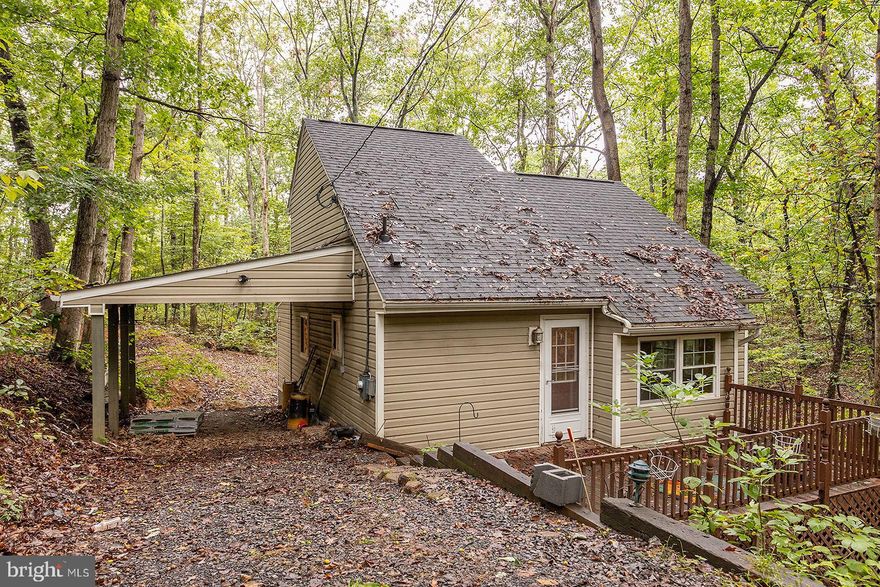 Peace and Tranquility! That's what you'll find at this cozy little chalet. Sit on the front deck and enjoy the wet weather stream or have your morning coffee on the rear screened-in porch. The main level features a bedroom and full bath. The kitchen is well equipped and there is a small sun room/breakfast nook. Vaulted ceilings in living room, and bedrooms. The upstairs bedroom has built-in bookcases. Priced to sell!