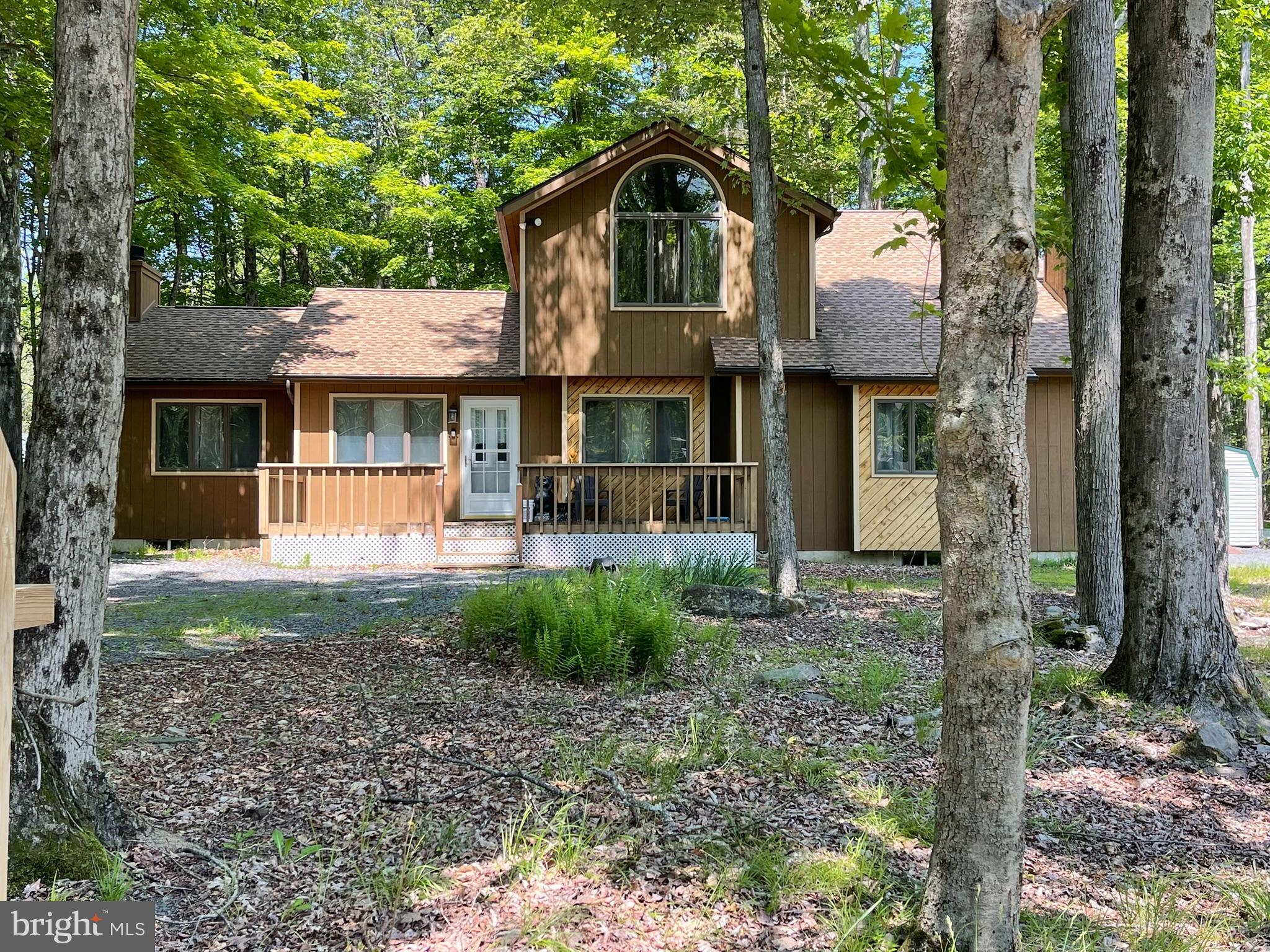 Welcome to this inviting 4-bedroom, 2-bathroom home in the highly sought-after, community of Arrowhead Lake. Whether you're searching for a short-term rental investment or the perfect family getaway, this property checks every box. Inside, you'll find vaulted ceilings, an open-concept living, dining, and kitchen area, and 2 cozy FIREPLACES to enjoy after a day of outdoor fun. The GAME ROOM offers extra space for entertaining, while the four generously sized bedrooms provide comfort for family and guests alike. Step outside to relax by the FIRE PIT or unwind on either the front or rear deck. Arrowhead Lake's impressive amenities include 3 outdoor pools, 2 lakes perfect for kayaking, 4 beaches, a clubhouse, and year-round activities for all ages. You're also just minutes from top Pocono attractions including Kalahari Water Park, Jack Frost & Big Boulder Ski Areas, Camelback Mountain, Lake Harmony with charming local restaurants, and a short drive to historic Jim Thorpe—all just 2 hours from Philadelphia or New York City. FALL IS THE PERFECT TIME time to make this Pocono Mountains retreat yours—secure it now before the leaves start to change and the season's beauty surrounds you.