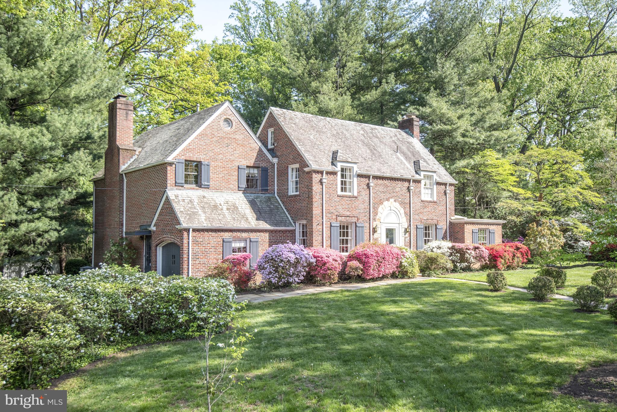 One of the showstoppers everyone has always admired! Built in 1941, this handsome home with its amazing curb appeal is on a lot of just under 1/2 acre, and the presentation with its abundant azaleas, dogwoods, roses, lily of the valley and more is exquisite. Owned by the same family for over 50 years, it has been beautifully expanded and lovingly maintained and now awaits its next steward. The residence offers 4,200 square feet of finished space over 3 levels, including the family room and primary suite addition ( 9+’ and 10+’ ceilings respectively), each with a wood burning fireplace. The thoughtful renovation focused on the connection between the indoors and outdoors, and windows and doors overlook the gardens from all vantage points possible. In addition to the living room with fireplace and dining room, the main level features a kitchen open to breakfast area and adjacent to the family room, an office area and a sunroom with floor to ceiling windows and doors and garage access. Four spacious bedrooms, including the primary, are upstairs, and a walk up attic is an ideal candidate for future expansion. The lower level includes a recreation room, potential in-law suite, full bath, laundry and utilities. The breathtaking lot is filled with mature plantings, a lovely rear patio, and ample green space for entertaining and play. In addition to the one car garage, parking in the driveway accommodates two cars side by side. Known for its beautiful homes and stunning, mature lots, the Bradley Woods neighborhood of Bethesda is located off Bradley Boulevard, and is approximately 1.5 miles from downtown Bethesda and its fabulous shops, restaurants and amenities. Revered private schools (including Landon, Holton and Sidwell Lower School) and the highly sought after public schools (Bradley Hills, Pyle, Whitman) that serve the neighborhood are all nearby, and another reason this location is so coveted. The location offers an easy commute to DC, points in MD, VA and beyond via main arteries, the Beltway and Parkway. A bus stop within 200’ also provides a quick ride to Bethesda to the red line metro. With its lush and mature greenery and tucked away location, this is the perfect spot for those who desire the charm and quiet of village life coupled with the conveniences of the city. This is one you do not want to miss!