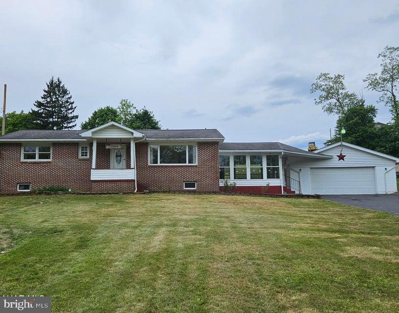 Sweet brick and vinyl 1 story in Antis Township! 2 large bedrooms, 1 updated tile bath, main floor laundry, eat-in kitchen with all appliances and great heated sunroom addition that leads to the 25 x 27 2 car garage! The basement is partially finished with an interior french drain and sump pump. 100amp electric.