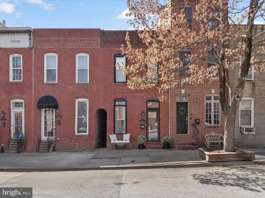 ***Multiple Offers received. Please submit all BEST & FINAL offers by 12:00pm on Monday 4/7*** Introducing this stunning Canton home, offering two bedrooms, two and a half bathrooms, and three beautifully finished levels in a prime location just blocks from the waterfront and the best of Baltimore. Designed for both style and functionality, this home boasts hardwood floors, a neutral color palette, crown molding, recessed lighting, and thoughtful updates throughout, creating an inviting and sophisticated atmosphere. An open-concept living and dining area is highlighted by an exposed brick accent wall, adding warmth and character. The custom-designed gourmet kitchen seamlessly blends style and practicality with soft-close cabinetry, an appliance garage, a pantry with sliding shelves, and deep drawers. Quartz countertops, a tile backsplash, brick accents wall feature, and a Kraus® workstation sink elevate the space while the high-end stainless steel appliances include a Bosch® refrigerator and dishwasher, a FORNO® gas range, and a built-in range hood. Just off the kitchen, a half bathroom also houses a full-sized stacked washer and dryer. Step outside to the back fenced patio, ideal for grilling and dining al fresco. Upstairs, the primary bedroom impresses with a vaulted ceiling, multiple closets, and an ensuite bathroom featuring a tiled tub-shower with sliding glass doors. Down the hall, the second bedroom showcases ornamental moldings, an open closet with a built-in organizing system, and a private ensuite bathroom with a walk-in shower. This level also provides access to the rooftop deck, an ideal retreat for relaxing or entertaining while enjoying sweeping city views. The finished lower level offers a versatile recreation room complete with a stylish bar featuring quartz countertops that complement the kitchen. A spacious utility room provides ample storage, ensuring both practicality and convenience. Located in the heart of the vibrant neighborhood of Canton, this home is moments from an array of restaurants, pubs, parks, shops, grocery stores, fitness centers and so much more. Stroll along the scenic waterfront just a few blocks away, discover the charming O’Donnell Square, or simply enjoy the lively atmosphere of this sought-after community.