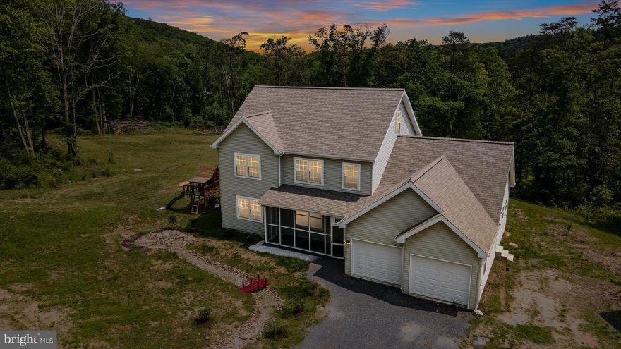May be one of the best deals on the market  – Now Listed at $400K! Seller is motivated due to a work change. This perfect home  includes 4 Unrestricted Acres!
Built in 2020, this 4-bedroom, 2.5-bath home offers a modern, open layout and is situated on 4 unrestricted acres with stunning mountain views. The main level features 8’ ceilings, large windows for natural light, a spacious dining area, and a generously sized kitchen with direct access to the attached 2-car garage. The primary suite is located on the main floor and includes an oversized ensuite bath with double closets and a tiled shower. Also on the main level: a dedicated office, laundry room, and half bath.
Upstairs you’ll find three additional bedrooms (one with a walk-in closet), a full shared bath, and a large bonus room ideal for a media room, playroom, or home gym. An additional 500 sq ft unfinished area on the third level offers even more potential for customization.
Outdoor features include a screened front porch, a large rear deck, two storage sheds, a spacious crawl space, a fire pit area, and beautifully maintained land. High-speed internet options include Starlink and buried fiber optic cable.
Conveniently located just 20 minutes to Winchester, VA, and less than 15 minutes to Wardensville, WV. Peaceful, private, and commuter-friendly. Be sure to check out the 3D Tour! Call today for more info
