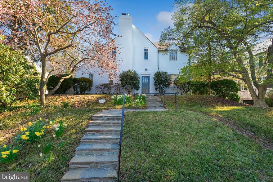 Elegant Tudor-style home in heart of Spring Valley off Fordham Road.  Built in 1930, this gem has stood the test of time with lovely hardscape and beautifully appointed gardens.  Located on one of the prettiest blocks in Spring Valley, this  house has superb light., elegant feel. The downstairs features a double living room with fireplace, sliding door out to the garden.  There is a lovely formal dining room.  The expansive eat in kitchen  (with new stainless appliances) and family room  face onto the large garden, big enough to build a pool.  Upstairs  boasts four bedrooms and four baths all on the second  floor, making it the perfect choice for those who want to be together on same level.. The Primary BR has 2 baths, and fourth BR is accessible through 3rd BR. The basement features a very large game or family room ready for your decor. There is a bright renovated laundry room, and small fifth bedroom with private bath.   But it's not just the layout that will catch your eye - the beautiful Tudor styling is timeless and instantly recognizable, and the outdoor space with specimen trees, plants offer chance to build a pool, play frame, other outdoor ideas. The walkability  location near Spring Valley shops and Metro bus makes this a superb location. This Tudor home offers the perfect blend of vintage charm and modern convenience.