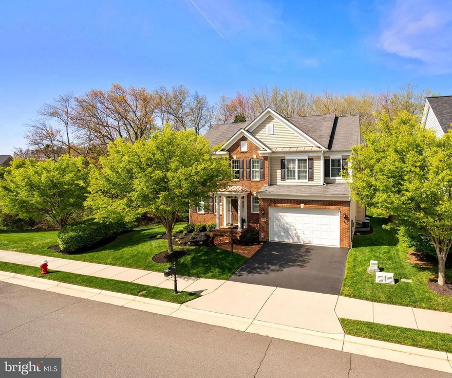 Welcome to 25167 Great Berkhamsted Dr.  A lovely brick front colonial with a welcoming front porch and a 2 car garage. This impeccably kept Winchester Danfield model has gorgeous Hardwood floors on the main level, staircase and upstairs hallway.  The main level is open and bright perfect for entertaining or having a family gathering.  The living room and dining room have beautiful plantation shutters and crown moulding, with chair rail in the dining room.  The gourmet kitchen has granite countertops, backsplash, stainless steel appliances, an island with seating, custom cabinets and plenty of room for a table.  French Doors open from the kitchen onto a sprawling deck with privacy from the tranquil trees in the backyard. The family room has a gas FP, ceiling fan and plenty of room for comfortable oversized furniture.  Walking in from the finished garage with built in storage , painted finished walls and ceilings and rubber mat flooring, there is a mud room perfect for coats and shoes and all the things that you want tucked away yet accessible. Upstairs there are 4 bedrooms and 3 fulls baths.  The light filled Primary Suite has 2 spacious walk in closets, tray ceiling and ceiling fan with room for a seating area and an en-suite bathroom with dual sinks, soaking tub, shower and private toilet.  Bedrooms 2 and 3 both have walk in closets and ceiling fans and share a Jack and Jill Bathroom with dual sinks.  Bedroom 4 has an En Suite Bathroom and a ceiling fan.  The laundry room is conveniently located on the Upper level right outside the Primary Suite. The lower level has a large open finished rec room with an additional bonus room with a walk in closet, full bath and a storage room.  The french doors from the basement walk you up into the backyard.  Close to shopping, restaurants, and Dulles Airport,  Aldie is conveniently located close to major commuters roads with the feel of the country just a few miles west in Middleburg.  The HOA offers many amenities or if you prefer, Chantilly National Golf and Country Club is right down the road.