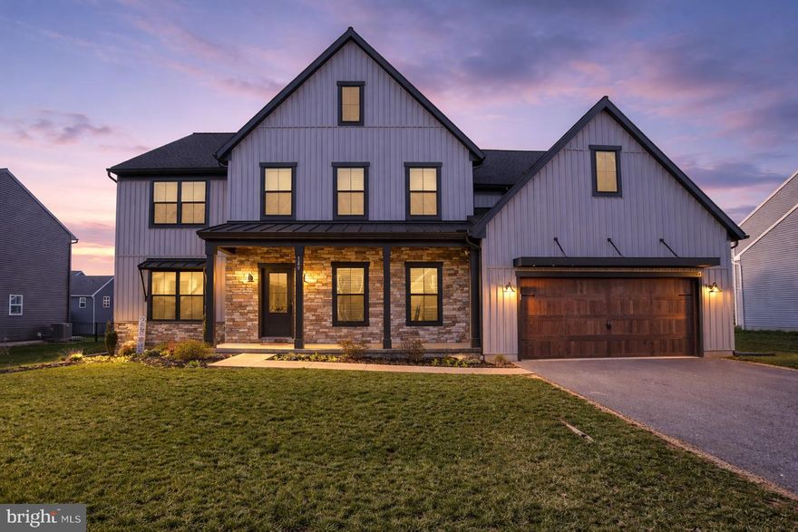 Welcome, to your new dream home! Stunning details abound throughout this stately two-story home, highlighted by a Craftsman-style exterior and charming front porch. The large two-car garage opens to a functional mudroom complete with a custom built-in storage tree, not to mention the large pantry and additional closet for even more storage space!

Moving towards the front of the home, a versatile living room and an elegant dining room showcase timeless wainscoting and chair rail detailing. The thoughtfully designed butler’s pantry connects seamlessly to the open-concept kitchen, featuring quartz countertops, tile backsplash, upgraded stainless steel appliances, and a large center island—perfect for both everyday living and entertaining. The bright breakfast area provides easy access to the rear patio.

Just off the kitchen, the impressive two-story great room offers a cozy gas fireplace with tile surround, creating a warm and inviting gathering space. Privately tucked away on the main level is a guest bedroom and full bathroom, ideal for visitors or multi-generational living.

Upstairs, the luxurious owner’s suite features a cathedral ceiling and a spa-like en suite bathroom with a freestanding tub, dual vanities, a tile shower, and an oversized walk-in closet. The second floor also includes a convenient laundry room, three additional bedrooms, and two full bathrooms.

Don’t miss the opportunity to make this beautifully crafted home your own—schedule your private showing today!