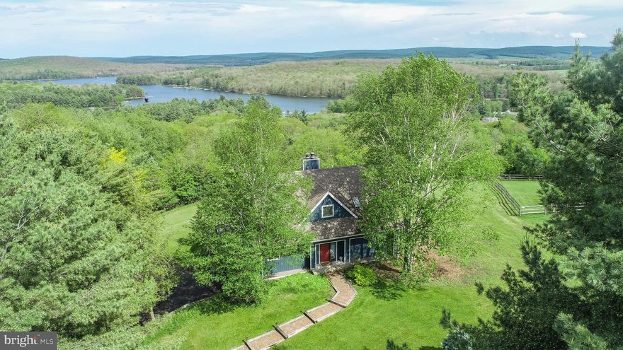 Panoramic mountain and lake views set the tone at this lake access home in Paradise Ridge, one of Deep Creek’s most sought-after communities! Perched at the top of the hill on 1.29 acres, this 4-bedroom, 3 full and 1 half bath retreat offers 3,780 finished square feet across three levels. Abundant glass frames the surrounding ridgelines with views of Deep Creek Lake from every room in the house! Two wood-burning fireplaces anchor the main living areas, while the open floor plan makes entertaining a breeze. The upper-level game room features a pool table and a balcony, adding extra gathering space. Tons of outdoor living, including an expansive deck, hot tub patio, and outdoor fire pit. Recent facelift on the exterior with a fresh coat of paint. An established vacation rental, “Paradise View,” is being sold turnkey/fully furnished and ready to go. Minutes from one of the nicest community lake accesses at Deep Creek Lake. If you’re looking for a home that sits just off the beaten path, but still provides easy access to all four seasons of Garrett County… this one needs to be on the list. Call today for details!