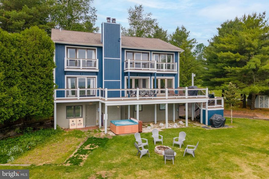 Panoramic mountain and lake views set the tone at this lake access home in Paradise Ridge, one of Deep Creek’s most sought-after communities! Perched at the top of the hill on 1.29 acres, this 4-bedroom, 3 full and 1 half bath retreat offers 3,780 finished square feet across three levels. Abundant glass frames the surrounding ridgelines with views of Deep Creek Lake from every room in the house! Two wood-burning fireplaces anchor the main living areas, while the open floor plan makes entertaining a breeze. The upper-level game room features a pool table and a balcony, adding extra gathering space. Tons of outdoor living, including an expansive deck, hot tub patio, and outdoor fire pit. Recent facelift on the exterior with a fresh coat of paint. An established vacation rental, “Paradise View,” is being sold turnkey/fully furnished and ready to go. Minutes from one of the nicest community lake accesses at Deep Creek Lake. If you’re looking for a home that sits just off the beaten path, but still provides easy access to all four seasons of Garrett County… this one needs to be on the list. Call today for details!