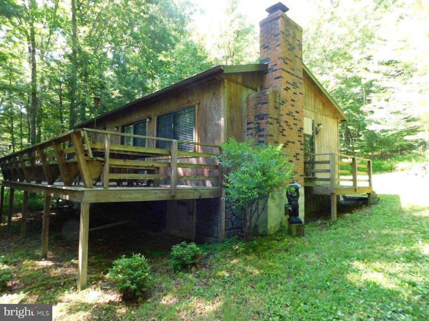 Perfect weekend cabin to hang out on the deck and enjoy the peace and quiet of the mountains.  2BR 1BA on 5.51 wooded acres adjoining the National Forest.  Private driveway and peaceful setting. Kitchen/living room combo. Two nice sized bedrooms and shared bathroom.  Relax by the fireplace on cold winter nights. Cabin would also be a good rental property.  Nice size shed for storage. Cabin comes furnished. Just bring your toothbrush!
 Minutes away from Lost River State Park, Kimsey's Run and Trout Pond Recreation Area, Farmers market.