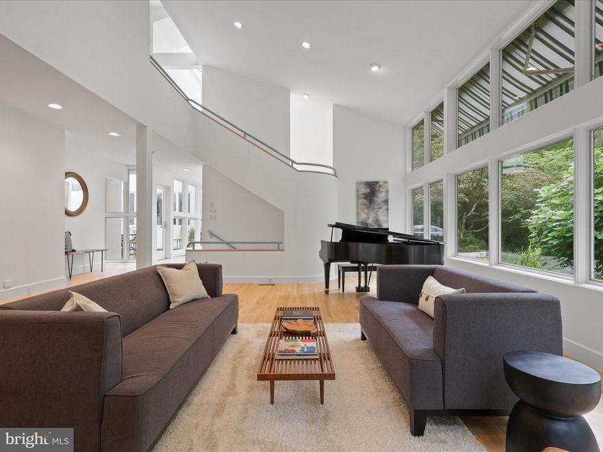 We invite you to this dramatic, light-filled home that sits amongst and blends with its scenic environment.  Recently refreshed with gorgeous refinished hardwood floors, fresh paint and new carpet, this residence is truly unsurpassed by its custom design and flow and provides a sound sanctuary where natural light abounds. From the entry with its substantial front door, walls of glass and skylights, to the curved stairwell, open living room and dining rooms with even more spectacular windows, you will find a home that embraces the surrounding landscape and trees.  Continue into the magnificent kitchen, breakfast room and huge family room with space to entertain a crowd. Just off of the kitchen is the screened-in porch with skylights. Off the main entry and passed the courtyard there is an office space with built in desks and cabinetry.  Also, on the main level is an ensuite guest room or den.  Upstairs overlooking the formal living room, you will find a sitting room/library with built-in bookshelves. The owner’s suite with its amazing windows and a private deck overlooks the courtyard, pool and the lush backyard. The primary bath has a dressing room, two walk-in closets, an enormous walk-in shower, bidet and a sauna.   An expansive hallway above the entry provides an abundance of natural light to the upper level and leads you to 3 more bedrooms plus a den/playroom.  On those sunny days, there are electronic retractable awnings to provide shade and comfort. Two of the bedrooms share a jack and jill bath and the third bedroom has an ensuite bath. All the bedrooms have built-in cabinetry. Plus there is another bonus room at the end of the hall!  And last but certainly not to be missed, on the lower levels are a half bath, a huge storage/utility room and a gym/basketball court with an approximately 14 ft. ceiling. The architect, Craig Hoopes, originally from Maryland, is now based in Santa Fe, NM. Hoopes is an award-winning architect known for designing contemporary styled homes and spaces.  His designs integrate comfortable indoor and outdoor living areas that invite a connection with the landscape.  Blurring the lines between indoors and outdoors is a hallmark of the Hoopes Architecture firm and this property is no exception. Outside the home there is a lovely courtyard and steps away is the beautiful, heated saltwater pool with surrounding deck. These spaces embrace the landscape and provide for secluded relaxation and enjoyment. Sitting on 5 park-like acres to explore, you shouldn't miss the pond at the bottom of the hill in the back. Plus the yard provides something for everyone with an area for a fire pit, climbing structure and a rope swing for kids! In addition to being refreshed in so many different ways, this home has been lovingly cared for meticulously maintained - Standing Seam Metal Roof! 2 of the 4 A/Cs were just replaced.  And don't forget, there is an additional 1-acre lot available to purchase at 2704 Chariton St.  This one -of-a-kind estate offers the perfect combination of suburban serenity and commuter ease.