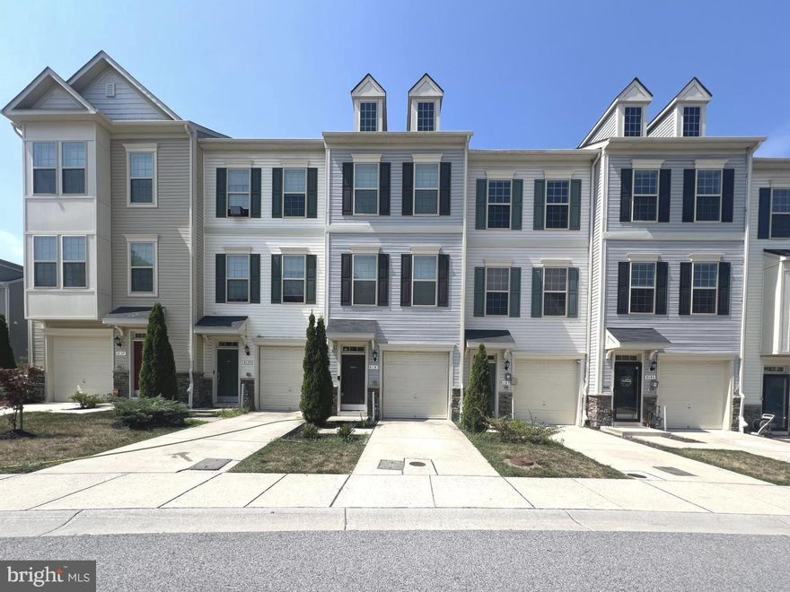 Beautiful Garage Townhome with Spacious Open Floor Plan. Welcome to this stunning garage townhouse featuring an open concept layout and neutral décor throughout. Enjoy the warmth of gleaming wood floors and neutral carpeting. The heart of the home is the incredible kitchen, perfect for entertaining, with a huge island, elegant espresso cabinets, and sleek granite countertops. The expansive living and dining area opens to a large deck through sliding glass doors—ideal for indoor-outdoor living. On the lower level, you'll find a versatile family room, a full bath, and walkout access to a fully fenced rear yard, offering both privacy and functionality. Upstairs, the spacious primary suite boasts a vaulted ceiling, a luxurious ensuite bath with a soaking tub, separate shower, and dual vanities. A second primary suite also includes its own attached full bath, providing comfort and convenience for guests or family members. Laundry is located in the upper-level hallway for easy access.  Located just minutes from Fort Meade, Washington D.C., Baltimore, BWI Airport, schools, shopping, and dining.