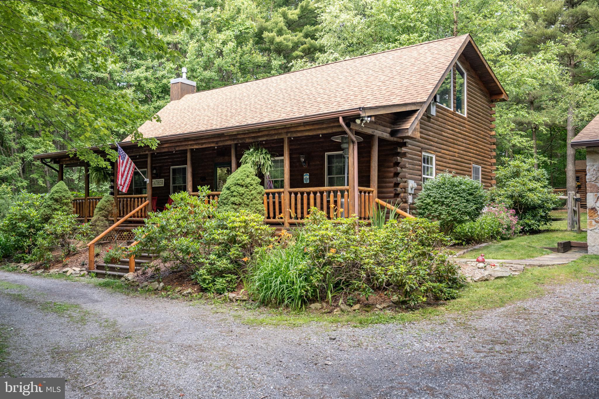 Cozy Log Cottage just minutes from Deep Creek Lake! This 4bed 2bath log home rests on almost 2 acres of private wooded land and is centrally located to everything Deep Creek has to offer. Open concept living with vaulted ceilings and a gorgeous stacked stone fireplace. Hard wood cabinets and granite tops with stainless appliances in the modern kitchen. Three beds and a bath on the main level, with a primary suite upstairs. Beautiful flagstone patio with built in hot tub and covered front porch offers plenty of outdoor living space. If you’re looking for that rustic mountain/lake retreat, with easy access to local amenities, but privately tucked away from and seasonal traffic… This is the home for you – Call today for details!