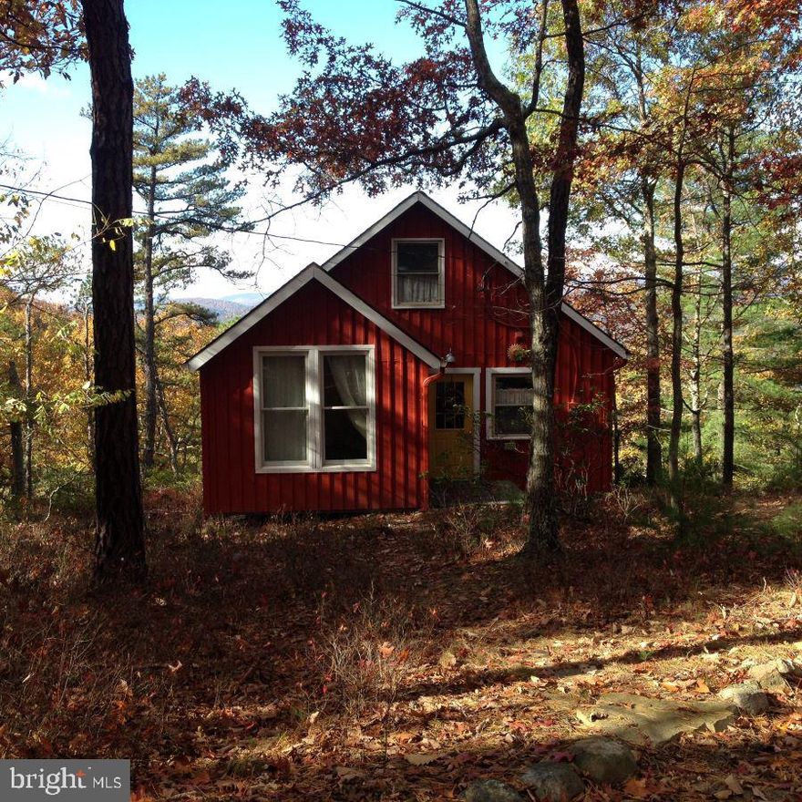 Charming Cabin with Unique Interior and a Truly Spectacular View! This cozy cabin Is located in a gated mountain development of Buck Ridges surrounded by 20 acres of lush forest and scenic woodland suitable for hiking, foraging and hunting. Hiking trails have been incorporated by the owner for meandering walks throughout the property. Oh, and don’t forget those breathtaking views of Kile Knob and the quaint, nearby town of Franklin.  There, you will find all the conveniences of home with that small town appeal where the people are friendly and welcoming. The cabin interior consists of a beautiful custom kitchen with gas cooktop, and an adorable built in to store your dinnerware.  From the kitchen, you'll enter the  combination living/dining area where a propane stove keeps the cabin comfy & warm on those chilly days. Off from the living area, you’ll find French doors leading to another sitting area/bedroom, you choose. Walk upstairs into the loft where there are three built in twin beds for those overnight guests. An additional room was added to the exterior of the cabin, previously used as office space, but currently used as an added bedroom. This room is accessible through a separate entrance by the front door, but it would also make and excellent private office for working during extended visits. Nearby attractions within 30 minutes to an hour include Seneca Rocks Recreation area, Canaan Valley, Blackwater Falls for all your beloved outdoor activities or you can choose to just settle in at the cabin with a good book and enjoy that magnificent view. You must see this cabin to truly appreciate its many distinctive features.   Higher clearance vehicle or 4x4 needed. Some covenants and restrictions apply.