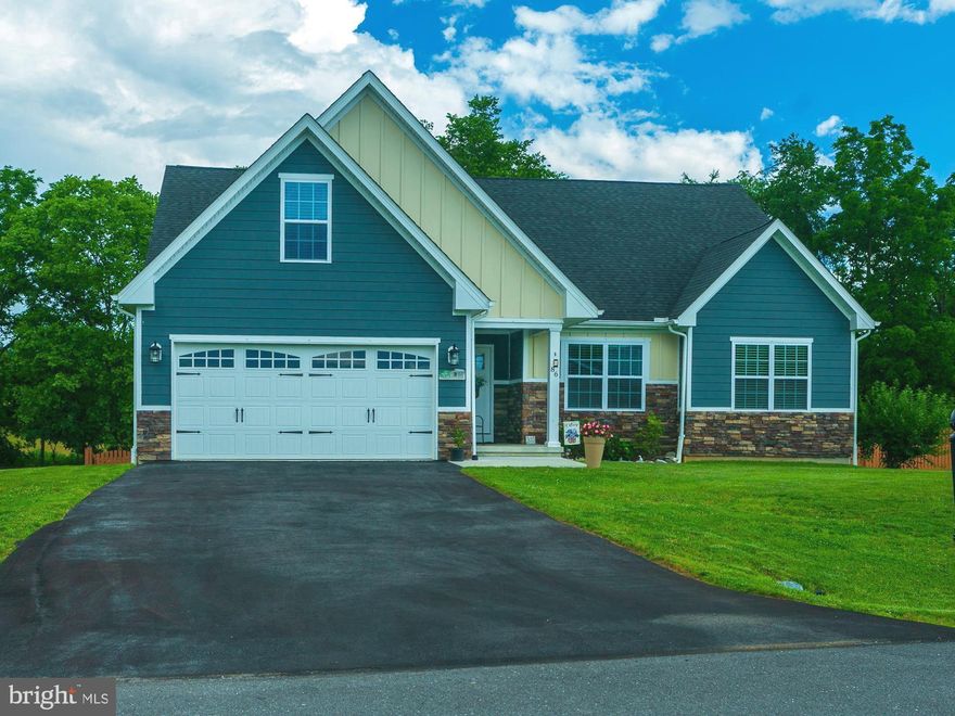 Welcome to The Springs at Shepherdstown!  This beautiful 4-bedroom, 3 full bathroom ranch-style home sits on just under an acre and offers a perfect blend of comfort, space, and style.  Step into a large foyer with ample room for a drop zone, accented by luxury vinyl plank flooring that flows seamlessly throughout the common areas. The open-concept design features a spacious family room that connects effortlessly to a large kitchen equipped with stainless steel appliances, granite countertops, a sizable kitchen island, and a designated dining area.  Just off the kitchen, enjoy outdoor living on the rear covered porch, with stairs that lead down to a fenced-in backyard — ideal for relaxing, entertaining, or pets.  The generously sized primary suite includes a large shower, soaking tub, dual vanities with tile backsplash, and a walk-in closet. For added privacy, two secondary bedrooms are located on the opposite side of the home and are separated by a full bathroom. The laundry room is conveniently located on the main level.  Upstairs, you’ll find a fourth bedroom with its own private full bathroom — perfect for guests or a private office space. The enormous walk-out basement is unfinished, offering a blank canvas for the new owner’s vision.  Additional highlights include a Culligan water softener and reverse osmosis system (both convey), and LeafGuard gutters installed in 2021.  Experience the perfect blend of comfort and opportunity in this desirable neighborhood — schedule your showing today!