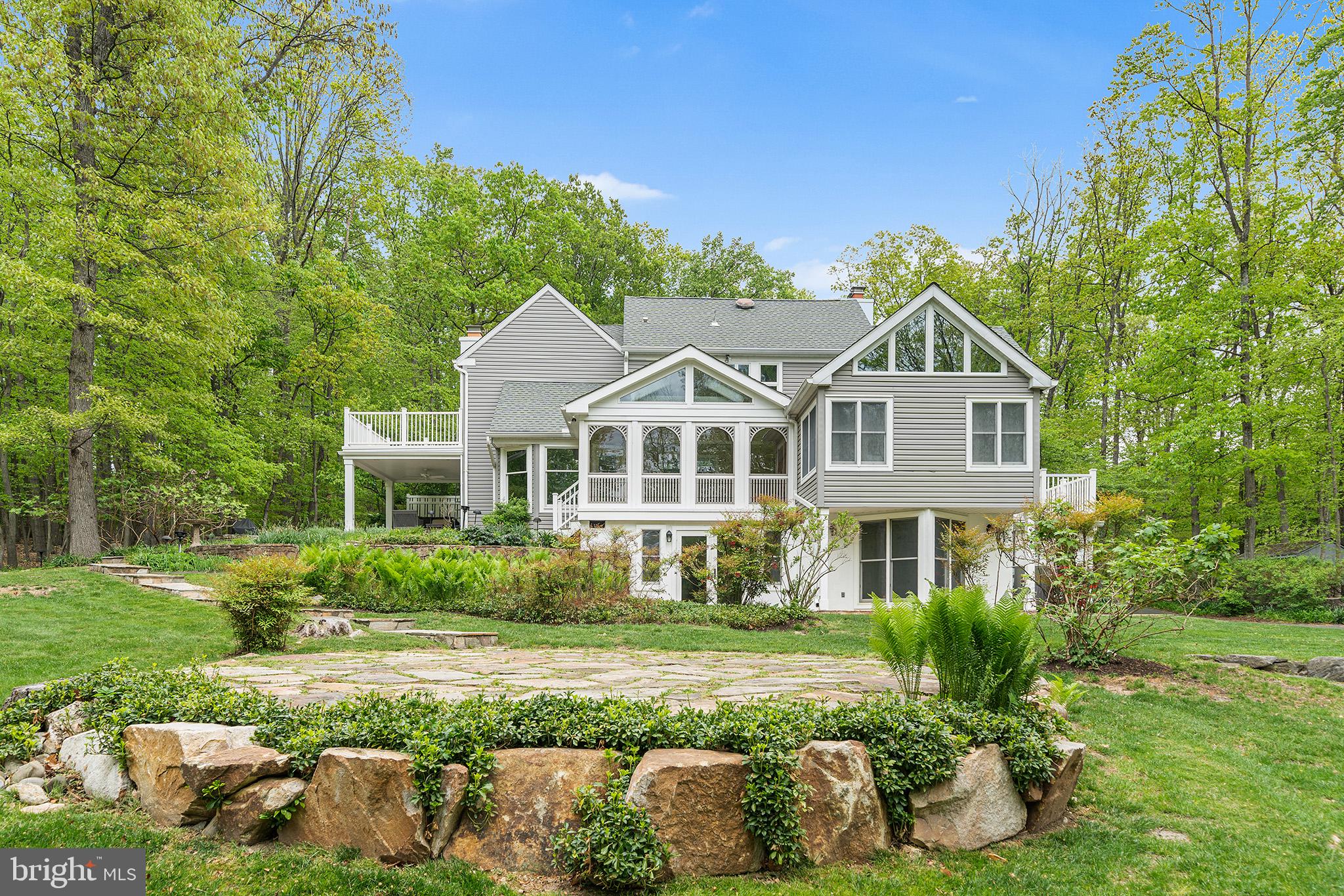 Welcome to 1600 Horseshoe Trail, Malvern, a timeless Chester County gem where classic architecture meets peaceful, refined living. Set on a beautifully wooded and private 2.8-acre lot atop bucolic Valley Forge Mountain, this stately 4-bedroom, 3.5-bathroom colonial offers approximately 4,000 square feet of versatile living space. Tucked into one of Valley Forge’s most picturesque and coveted neighborhoods, this home is a rare blend of seclusion, space, and convenience. Located just minutes from downtown Malvern, Valley Forge and Phoenixville, with easy access to commuter routes, it also boasts being within the top-ranked Tredyffrin-Easttown School District—one of the most sought-after in Pennsylvania.
Step inside to a traditional, well-thought-out floor plan that blends classic design with everyday comfort. The main level features impeccable wide plank wood flooring throughout and the living room and formal dining room are filled with natural light and private outdoor spaces — perfect for entertaining or relaxing. The adjacent eat-in kitchen hosts an expanded island, fireplace and enclosed porch offering additional space for casual living, dining, or hosting year-round.
On the main floor, you'll find two comfortable bedrooms featuring hardwood floors, large windows, and ample closet space. A well-designed Jack and Jill bathroom connects the bedrooms, while a convenient half bath adds functionality for guests. The laundry area is also located on this level for easy access. Upstairs, the top-floor en suite serves as a private retreat with a spacious layout and peaceful ambiance, a spa-inspired bathroom includes a deep soaking tub, a walk-in shower, and distinctive, character-rich tile. The suite extends into a comfortable living area and dedicated office—ideal for working from home or simply enjoying some quiet time. Step out onto the private balcony for a morning coffee or to unwind at sunset, blending indoor comfort with outdoor living.
The property also includes a large finished lower level with a private-entry guest apartment or in-law suite, complete with a full bathroom, built-in closets, and kitchenette—ideal for multigenerational living, guests, or remote work.
Outdoors, the home is surrounded by professionally landscaped grounds, flat grassy areas for play or gardening, and wooded buffers that ensure year-round privacy. A two-car garage and work area add convenience and storage.
The utilities and mechanicals have been thoughtfully designed, well maintained and updated, reflecting the care of long-term ownership. This home features three fireplaces—one wood-burning, two propane—three heating zones for efficiency and comfort, and a full-house generator. The home offers easy access to the Valley Forge Mountain Swim and Racquet Clubs, the popular Valley Forge Mountain Association, as well as nearby walking trails, and numerous community events.