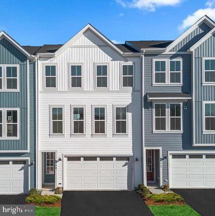 This brand-new never lived in TOWNHOME is ready for you to move in almost IMMEDIATELY! Step into contemporary luxury with the captivating Truett 24-F2 floorplan by Van Metre Homes in SNOWDEN BRIDGE. Spanning 2,412 finished square feet across three meticulously crafted levels, this exquisite townhome offers an unparalleled blend of style, comfort, and convenience. Boasting three bedrooms, two full and two half bathrooms, with a convenient 2-car front load garage, this residence is designed to exceed expectations at every turn. As you step inside, you'll find a versatile multipurpose rec room, equipped with a half bath, this space provides ample opportunity for relaxation and entertainment, with easy access to the private rear backyard, ideal for outdoor gatherings and leisure. Venturing up your oak stairs, found throughout the home, you’ll be greeted by a meticulously crafted living space adorned with 9' ceilings, this main level showcases a sprawling great room and dining area, seamlessly connected to a captivating kitchen featuring a central island, upgraded cabinets, tile backsplash, quartz countertops, wood shelves within your walk-in pantry, and luxury vinyl plank flooring – the epitome of modern elegance and functionality. After making your way to the upper level, you’ll discover the haven of relaxation that exists within the impressive primary suite, complete with a generous walk-in closet and a luxurious 4-piece bathroom boasting double sinks and a frameless shower with a built-in seat – the perfect retreat after a long day. This level also hosts two additional bedrooms, another full bath, and a convenient upstairs laundry room, offering unparalleled convenience and comfort. Being a new build, your home is constructed to the highest energy efficiency standards, comes with a post-settlement warranty, and has never been lived in before! Don't miss out on this incredible opportunity to own a home that seamlessly combines modern luxury, thoughtful design, and resides within a prime, highly desired location. Schedule your appointment today! ----- Discover Snowden Bridge, a premier master-planned community located within the heart of the Shenandoah Valley, only minutes from the Downtown Winchester area. With its selection of townhomes and single-family homes, Snowden Bridge creates the perfect opportunity to create nurturing relationships with neighbors; where life revolves around connection, recreation, and relaxation. Surrounded by the hills of the Blue Ridge Mountains, this community offers outstanding resort style amenities, including swimming pools - inclusive of a splash park for the kids, a 15,000 sq.ft Indoor Sportsplex with basketball, tennis and volleyball courts, a dog park, playgrounds, a picnic pavilion, bike racetrack, miles of walking trails, an on-site daycare and on-site elementary school. End your days with family and friends catching stunning sunsets. Moreover, Snowden Bridge is conveniently located minutes away from major roadways & interstates such as route 7, I-81 and I-66, ensuring seamless connectivity to the region. Offering the perfect blend of small-town charm and modern-day convenience, easily access Snowden Bridge’s closest shopping center, Rutherford’s Crossing, etc