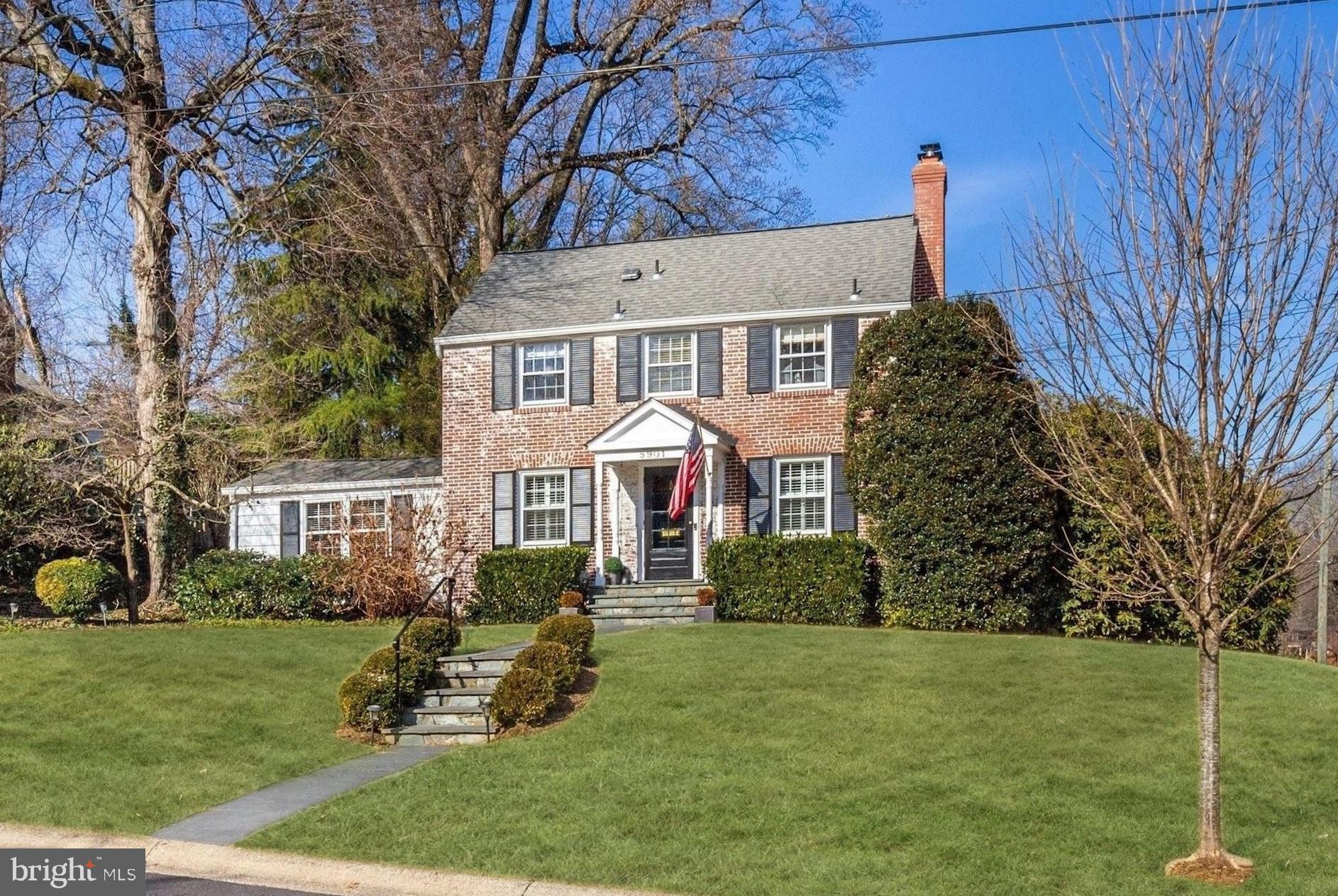 JUST LISTED in Woodacres! Open Houses Saturday (2/26) and Sunday (2/27) from 1-4pm. Offers due Tuesday (March 1) at 12:00pm.
This handsome 1955 brick colonial is full of charm and curb appeal, on a sunny southeast facing corner lot with mature landscaping. A front portico entry opens into the Main Level foyer with hardwood floors that flow throughout the Living Room with fireplace, Family Room with cathedral ceiling, stainless steel Kitchen, formal Dining Room, Powder Room, and Den / Home Office. A sliding glass door from the Family Room walks out to the spacious rear deck and garden. The Second Level offers 3 Bedrooms and 2 Full Bathrooms upstairs, including the Master Bedroom with en suite. The Lower Level includes a Recreation Room, second Powder Room, Laundry and Storage Room, and direct access to the home's 1-Car Garage.