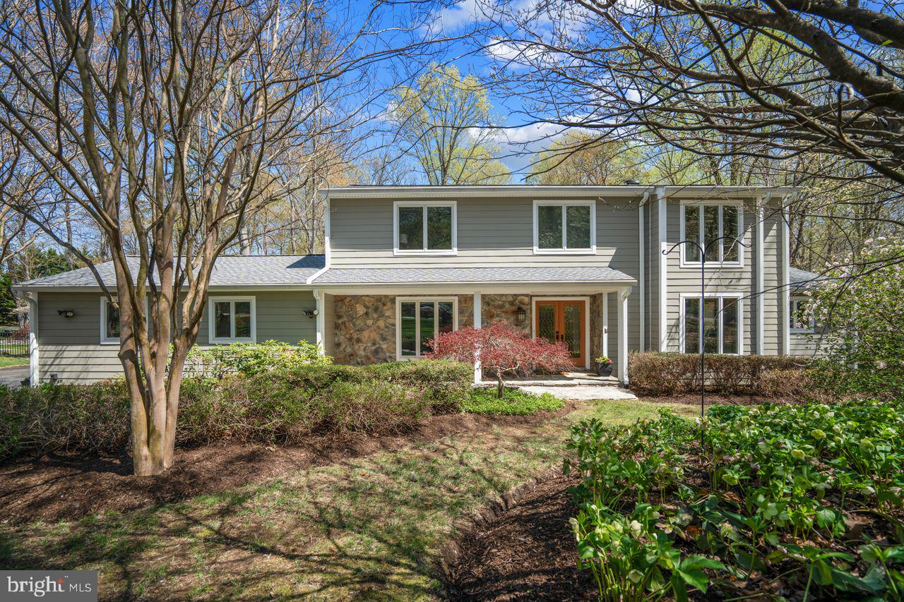 Tucked away in a serene wooded setting, this stunning contemporary home is designed for both comfort and entertaining. With soaring cathedral ceilings, expansive windows, and multiple decks, it seamlessly blends indoor and outdoor living.
Inside, you’ll find four bedrooms (including a versatile first-floor bedroom that can serve as a den or office) and three full bathrooms. Hardwood floors flow throughout, leading to a separate dining room, and a spacious eat-in kitchen equipped with stainless steel appliances, quartz countertops, two sinks, and a trash compactor.
The family room and living room, both featuring dramatic cathedral ceilings, are warmed by two beautiful stone wood-burning fireplaces. A wet bar with a stainless steel sink makes entertaining a breeze, while the first-floor laundry room includes a washer, dryer, and a convenient laundry chute from the upstairs bathroom.
Attached two-car garage is complemented by a paved driveway with an additional parking space.
A backup generator that powers the entire home ensures peace of mind.
Step outside to enjoy the screened porch, three composite multi-tier decks, and stone paver walkways—all surrounded by lush landscaping. The stone and HardiPlank exterior is paired with a five-year-old roof and two Velux automatic screened-skylights, and a freshly painted interior for a crisp, move-in-ready feel.