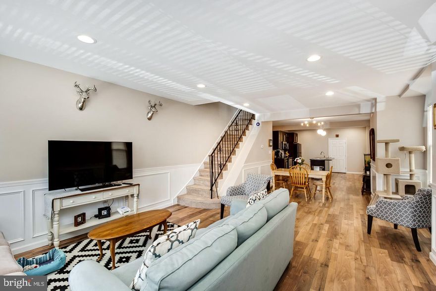 Sunlight from ceiling to floor add to the West Philly end units lovely decor. Glorious mornings can be enjoyed on this classic West Philly porch, watching the passers-by, and the daffodils growing in the yard. Inside the airy, clean feel is assisted by recessed lighting, and the width of the home. Entertaining? The transition from food preparation to living space is seamless, so everyone feels connected, and a large island lends itself to gathering and placemaking. A mud room with laundry center and powder room rests behind the kitchen, which leads to a rear deck ready for summer cookouts. There's even enough yard space for the pups to stretch their legs on cold winter morning. Updtairs 3 well apportioned bedrooms await. The master, which is graced by a classic Victorian bay window, is bestowed with an  bathroom enormous bathroom with a double sink.  Downstairs find more liveable space with a finished basement. Central Air, and Forced Air Heat, keep this home climate controlled.  This home feels spacious, yet manageable. Location is fantastic for public transit, with a bus on the corner, and 2 blocks to the El train, Center City, and the Universities are minutes away. This propery qualifies for both the Penn forgiveable loan program and the Closing Cost Reduction Program at PHOS. Book your appointment today!