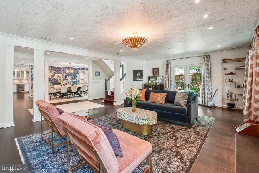 Tucked away in the charming Wakefield neighborhood, between Wisconsin and Connecticut Avenues NW, this stunning six-bedroom, three-and-a-half-bath residence offers 4,775 square feet of elegant contemporary living. No detail was overlooked in the design and construction of this extraordinary home, where impeccable craftsmanship meets top-tier finishes. With luxurious materials such as Ann Sacks and Architectural Ceramics tiles and hand-painted wallpaper, it’s no wonder this home was featured in the Washington Post Style section. Complementing the home's sophisticated design, a professionally installed Sonos sound system delivers high-fidelity audio throughout the interior and outdoor living areas. More recent upgrades include Pella patio doors and double-hung wood-framed windows, as well as 10” wide white oak flooring throughout the main level and a state-of-the-art 17.85 kW solar panel system that adds energy efficiency to the long list of premium features.  The formal living and dining areas, with direct access to the stunning hardscaped patio, offer an ideal layout for sophisticated entertaining. The gourmet kitchen includes a six burner Viking range, two ovens, commercial sized Thermador refrigerator and freezer, dual Miele dishwashers, built-in Miele coffee maker and warming drawer, and center island seating for five highlighted by Jasper Morrison pendants. The second floor features a luxurious primary suite with a spa-inspired bath, complete with dual vanity, glass-enclosed shower, Victoria + Albert soaking tub, heated floors, and direct access to a spacious walk-in closet. Just off the primary suite, a spectacular 700-square-foot solarium offers a versatile retreat, currently serving as a family room, children's play area, and home gym, surrounded by custom Lutron privacy shades. This level is completed by two additional bedrooms and a second full bath with a soaking tub. Ascend the Stark carpeted staircase to the third floor where you’ll find three generously sized bedrooms and a beautifully appointed full bath featuring a custom-tiled shower and dual vanities, providing ample flexibility for family, guests, or dedicated home office space. The multifunctional outdoor space includes a 1,350 square-foot patio thoughtfully designed for entertaining. Enjoy al fresco dining with an Argentinian-style “parrilla” wood grill and built-in ice chest, cozy sitting area with a gas fireplace, and a third lounge currently serving as a play area. Beyond the patio lies a sun-drenched, south facing lawn, fully enclosed by a 6-foot privacy fence, creating an inviting outdoor retreat.