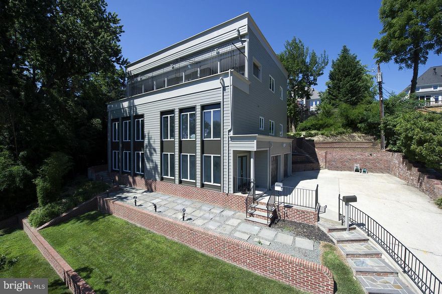 Stunning hilltop contemporary overlooking Crystal City & beyond.  Spectacular master retreat w/ en-suite bath, lg. walk-in closet, private office, separate den, additional bath and private deck with views!  Spacious gourmet kitchen w/breakfast bar, soaring ceilings, Italian Carrera marble throughout, 2 car gar. rear brick patio and front terraced gardens.