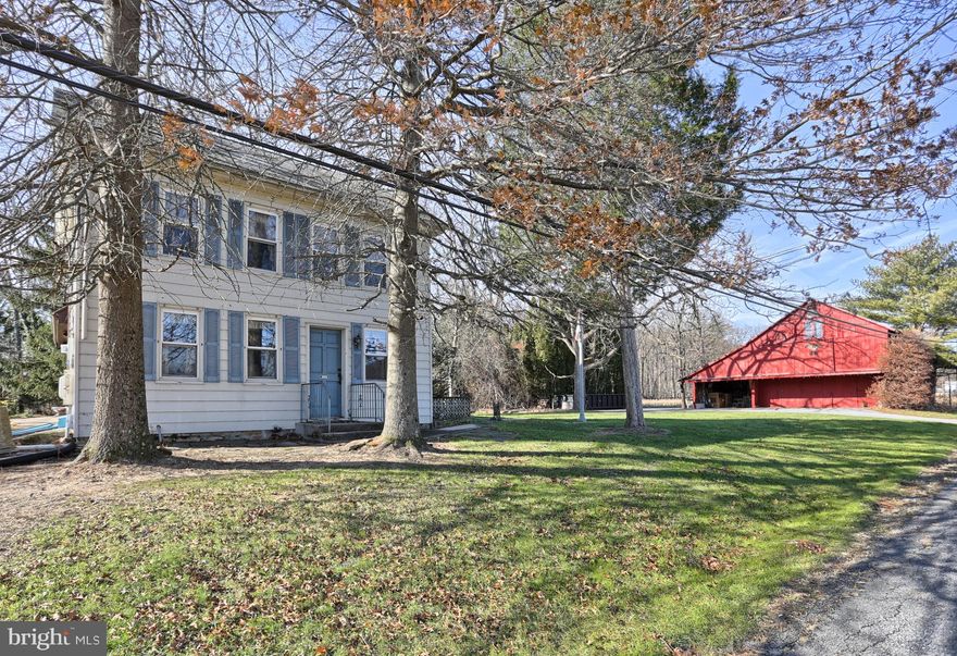 Charming 19th century farmhouse with 7+ acres, some of which are tillable. Includes a barn with multiple garage spaces and carport, a 4 bay shed and smaller sheds. 2 story great room features local barn wood beams, ceramic  tile floors, skylights and open stairway to second floor. Original wide plank wood floor in living/dining area and wainscoting.