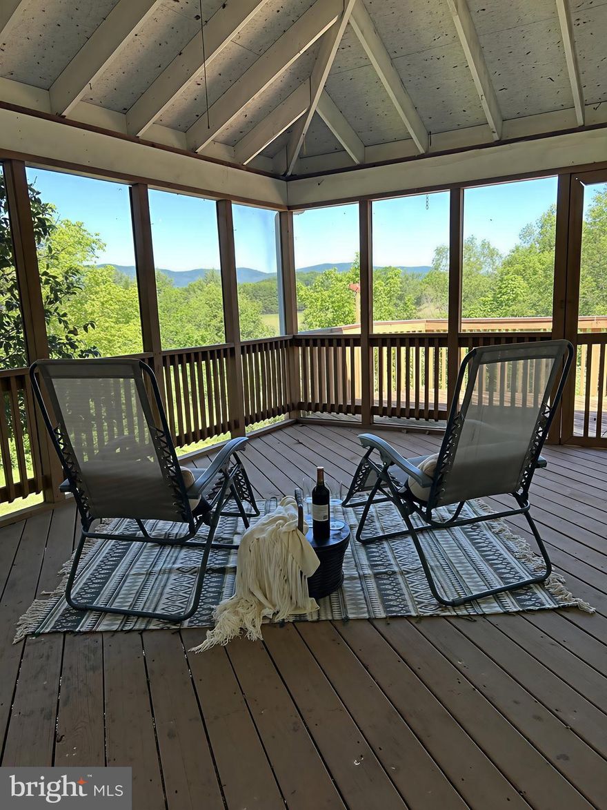 IT'S A LIFE STYLE - YOUR FRONT ROW SEAT TO THE MOUNTAINS!
You know that feeling when you finally exhale?  That is this property.  Tucked away on 5 private acres just minutes from town, this one-level home captures breathtaking 360-degree mountain views from nearly every angle--sunrises to the southeast, glowing sunsets to the northwest.
You cannot see the home from the road, and once you arrive, the outside world disappears.  Inside, the home offers over 2,500 square feet of comfortable one-level living with:  4 oversized bedrooms, 3.5 bathrooms, a warm brick fireplace, a large dining room for gatherings, a library with built-in shelving and inspiring views, and main - level laundry hookups.
The real magic happens outdoors!
A screened porch, multiple decks, and two separate sitting porches invite you to follow the light throughout the day -- coffee at sunrise, wine at sunset, storms rolling across the mountains in between.
Additional features include:  Two tax IDs, a full basement with a family room, workshop space, and an additional full bath, pole barn for equipment or hobby storage, NO HOA,  and priced below tax assessment and recent appraisal for INSTANT EQUITY.  Home being sold As-Is.
Private, scenic, usable, and impossible to replicate!

Roof replacement 2019, siding replacement 2020, well pump/pressure tank replaced 2022.
HVAC has 2 propane furnaces w/400 gallon storage tanks (owner owned) plus 2 AC units.  East furnace replaced in 2016 and west furnace replaced 2022.  AC units replaced in 2024.
Whole House generator added 2015. active radon system, Septic pumped 2025.
UV Sterlization unit and filter added to water system 2022.
Pioneer style cooking wood stove in basement.
2025 survey with boundary markers set (This will help save on owner's insurance).