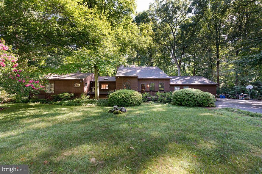 Discover Tranquil Elegance in Valentine Creek
Nestled in the serene community of Valentine Creek, this exquisite detached home offers a perfect blend of privacy and luxury. Set on a picturesque 1-acre lot, the property boasts tranquil views of lush woods and abundant wildlife, providing a peaceful retreat from the everyday hustle.
The home boast a unique floor plan with three finish floors. Separate  and unique space for all!
Home Features:
Bedrooms & Bathrooms: This spacious residence features 4 generously sized bedrooms and 4.5 beautifully renovated bathrooms. The main level hosts a primary suite with an expansive ensuite bathroom, showcasing a modern walk-in shower adorned with unique contemporary tile decor. A pellet stove in the hallway adds a touch of warmth and coziness to this level. The upper floor includes a second primary suite with its own ensuite bath, along with a third bedroom serviced by a hall bath. The lower level completes the home with a fourth bedroom and an additional full bath, along with a versatile flex space ideal for a home office or recreational area.
Living Spaces: The inviting living room at the rear of the home features a wood-burning fireplace, perfect for relaxing evenings. Enjoy seamless indoor-outdoor living with two stunning decks: one extending from the rear living room and the other adjacent to the main level primary suite. Enclosed previously screened room used as a garden/planting room.
Kitchen: A chef’s dream, the recently renovated kitchen is equipped with gorgeous cabinetry, elegant granite countertops, and sleek black appliances, including double wall ovens for culinary enthusiasts. Large island with plenty of space for a table. Huge walk in pantry just off the kitchen.

Additional Features: The property includes a large 2-car garage with ample storage space, ensuring convenience and organization. Mud room with laundry and half bath off of garage entrance. Small outdoor shed and play equipment conveys. Large finished living space 2894 finished above ground with 1387 finished below grade.

Embrace the harmony of nature and modern comfort in this exceptional home. Schedule your visit today to experience the serene lifestyle and sophisticated design that await you in Valentine Creek.
Smiths Marina and water access close by. Commuting is a breeze with RT97, RT50 and RT3/301 all close by. Annapolis is a 15-20 min drive.