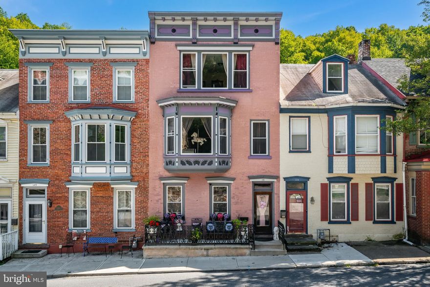 Step into a piece of history with this stately Victorian-style 5-bedroom, 1.5-bath home, offering nearly 2,400 SF of living space in the heart of Jim Thorpe. Rich in character yet thoughtfully updated, this residence features an updated kitchen with custom cherry cabinets, a large center island, granite countertops, and gas cooking. Period details shine throughout—from the original wide-plank hardwood floors and intricate marble tile work to the soaring 9'+ ceilings that create a light, airy feel. The primary bedroom's large bay window frames picturesque views, while the front porch, adorned with ornate wrought iron, evokes the elegance of a bygone era. Enjoy a private backyard oasis complete with a tranquil under-the-tree sitting area, perfect for unwinding. Additional highlights include gas heat, low taxes, and a peaceful setting just a short stroll to downtown Jim Thorpe's shops, dining, and attractions. This rare Victorian beauty blends timeless craftsmanship with modern convenience in one truly special home.