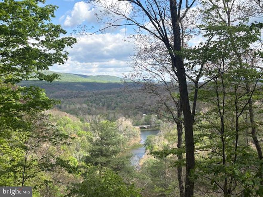 Check out this lovely home on over 20 unrestricted acres with a beautiful view of the Cacapon River..Enjoy the privacy location, while sitting on the nice back deck just listening to the peace and quiet.  This home offers a lot of space for you to enjoy. Large master bedroom with Walkin closet and separate bath. Enjoy the studio/sunroom for relaxing and doing what you love to do. Nice large room below the sunroom for a rec room or separate space for guest, just use your imagination.  Plenty of space outdoors to put up a nice garage or just for having fun on the weekends. With unrestricted land, you can decide what you would like to do.