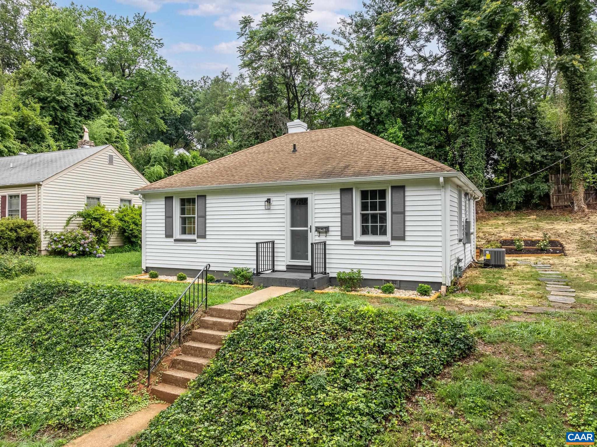 Wow! Completely renovated inside with new modern HVAC, new Tankless Hot Water Heater, new Kitchen, New Bathroom, new windows, new drywall and refinished floors! This charming cottage home tucked off of Rugby Road is surrounded by mature trees, with a newly landscaped and seeded yard. Inside, the cozy living room opens to the remodeled kitchen with quartz countertops, tile backsplash, white cabinets, and stainless steel appliances. Everything is brand new! Two bedrooms share a full hall bathroom with new tiled floor and shower, new plumbing and a high-end washer/dryer combo hidden behind the sliding barn door! A flexible room next to the kitchen can be a home office, dining room or third bedroom. New tankless hot water heater for instant hot water too! Enjoy the beautiful landscaping around the patio at the rear of the home. Don't miss your chance at this city charmer!,Quartz Counter,White Cabinets