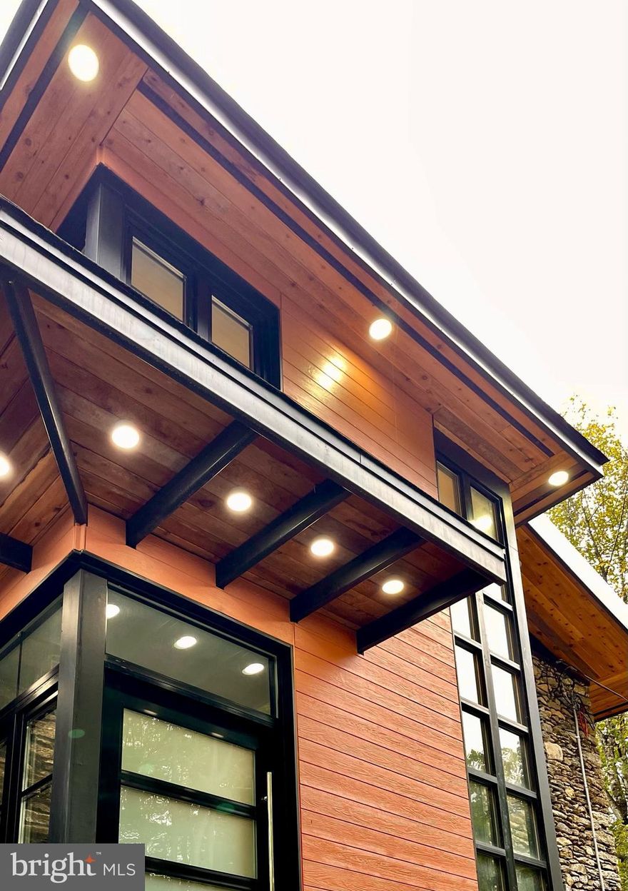 Fully Rebuilt From Ground Level to Three Floors.  One of a kind build incorporating a vintage feel with modern materials and open floor plans.  The views out of this home are just breathtaking!  Large steel framed double x 2 insulated custom made windows from Denmark are just the tip of the iceberg for this astonishing build!  Large Atrium Ceiling upon entry of the front door with 8, yes 8 skylights welcome you into the home.  A Private entranced studio Style In-Law-Suite at the entrance level with a kitchen/living area, private laundry, full bathroom and single bedroom perfect for a college student or live in Nanny.
To the right notice the cedar planked accent wall from ground level up three floors.  The butcher block stairs accented by wrought iron railing puts the eye pleasing touch to a very modern yet comfortable home filled with nostalgia.  Details abound in this restored Farmhouse.  Midnight Blue Cabinetry in the Gourmet Kitchen with Brushed Gold Hardware, White Farmhouse Sink, Six Burner Stove with a hidden downdraft system built into the Stovetop.  Amazing design and features throughout.  Honestly, too many to list.  Please, get here and see for yourselves.  European style baths with open showers are also a very nice feature.  Large two acre lot surrounded by trees with a secluded yard not accessed by another road. Within walking distance of the Pennypack Trail and Lorimar Park.  Privacy abound in this transformed Vintage Farmhouse.  Every modern amenity you could think of and then some.  Please allow one hour time slots for all showings.  There is a lot to see here and you don't want to miss any of it!