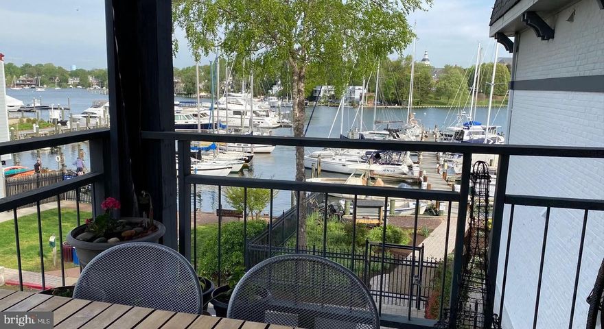 Waterfront living in Eastport—renovated, reimagined, and ready to enjoy. This light-filled condo has been smartly reconfigured to maximize both space and views, with a custom-installed picture window that pulls in natural light and frames Spa Creek beautifully. The open-concept layout flows easily from kitchen to living area to the oversized private deck—where waterfront living truly shines.

The deck offers front-row views of Spa Creek and the marina, with plenty of room for both dining and lounging. It’s been upgraded with a custom awning system that encloses all sides for shade and shelter, plus water-resistant polypropylene flooring for year-round function and durability. Inside, the updated kitchen features custom cabinetry, Corian countertops, and stainless steel appliances. Solid hardwood bamboo flooring runs throughout, laid over Bella Premium underlayment for extra comfort and sound absorption.

Two newer Mitsubishi mini-split HVAC units handle heating and cooling efficiently. Additional updates include in-unit washer/dryer, smart built-in cabinetry, induction stovetop, and thoughtfully updated fixtures and finishes throughout. The unit includes secure building storage, plus general and assigned parking—conveniently located close to the entry for easy unloading.

This secure condo community offers some of the lowest monthly fees in Eastport and a truly prime location—right on the edge of Spa Creek, at the end of a dead end street, so it is nice and quite, right next to Burnside Park. The list of amenities includes a waterfront pool, clubroom, fitness studio with showers, an outdoor grilling/dining area overlooking the water and kayak storage as well as a launch point. A deep-water marina is just steps away, and you’re minutes from downtown via water taxi. Pet-friendly and short-term rental–friendly—ask for details.