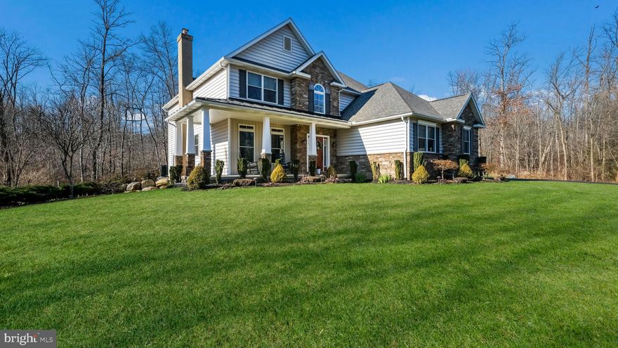 Welcome to the elegance of 1888 West Rock Road, a splendid home constructed in 2016, showcasing 4 bedrooms, 3.5 baths, a 2-car attached garage, an additional detached 32’ x 35’ pole barn, and an in-ground salt-water pool, all nestled on over 7 acres of secluded bliss with captivating hilltop views. As you ascend the tree lined driveway, this custom home welcomes you with its wrap-around porch and ample parking, creating an inviting atmosphere for all occasions. Step through the front door to discover a welcoming 2-story foyer and engineered hardwood flooring that graces the entire first floor. A versatile flex room, perfect for a home office or formal dining, sits on the left side, featuring French glass doors that open into a truly open-concept space. The expansive family room is adorned with abundant windows for natural light, a gas fireplace, also prepped for wood burning, crown molding, and recessed lights. Seamless continuity leads you to the Chef’s delight, the kitchen, equipped with stainless appliances, an exposed hood vent, 5 burner gas cooktop, a spacious center island, ceramic tile backsplash, granite countertops, walk-in pantry, and ample cabinetry and counterspace- an ideal setup for hosting your next party or holiday gathering. A convenient half bath completes the first level. Ascending the turned staircase with oak steps and custom metal balusters, you’ll reach the primary bedroom suite featuring a tray ceiling, beautiful views all around, a ceiling fan and generous closet space. The primary bath is a luxurious retreat with heated floors, dual vanities, ceramic tile, private water closet, a soaking tub and a spacious shower stall with frameless doors. Three additional well-proportioned bedrooms, full bath, and a conveniently located laundry room complete the upper level. Venture to the finished, walk-out, lower level French doors leading you outside. This level features a full bath, a game room, and a large unfinished area currently utilized as a gym. Outside, a heated, saltwater in-ground pool was added in 2020, surrounded by stamped concrete, a beautifully covered porch for your outdoor dining and enjoyment, and a fenced area providing safety and access to the side and backyards.  In 2019, a custom pole barn was constructed, offering a fully poured concrete slab, abundant storage, tall ceilings, workshop space, 2 side garage doors and a pass-through 14’ door – perfect for a boat or large vehicle. The barn includes a pellet stove for warmth and a custom pet door leading to a small fenced area for your furry friend. The expansive yard invites various outdoor activities, complete with a trail leading to the scenic depths of nature. Mature landscaping adorns the property, complemented by exterior lighting, presenting a move-in ready ambiance. The home features geothermal heating and cooling for maximum efficiency in utility bills, along with a whole home generator. Located just 10 minutes from Perkasie Borough, 20 minutes from Doylestown Borough, and minutes away from Lake Nockamixon, with easy access to major traffic routes such as Rts 313, 563 and 309. Schedule your showing today and make this tranquil haven at 1888 West Rock Road your next cherished home.