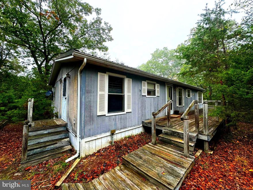 If you are looking for seclusion and privacy look no further! This home is nestled away in its own pine thicket. With over 2 acres of property for exploring you have plenty of room. Inside there are laminate floors through out with over sized windows for all the natural light! A private primary bedroom and bath will leave you feeling like the king or queen of this castle.