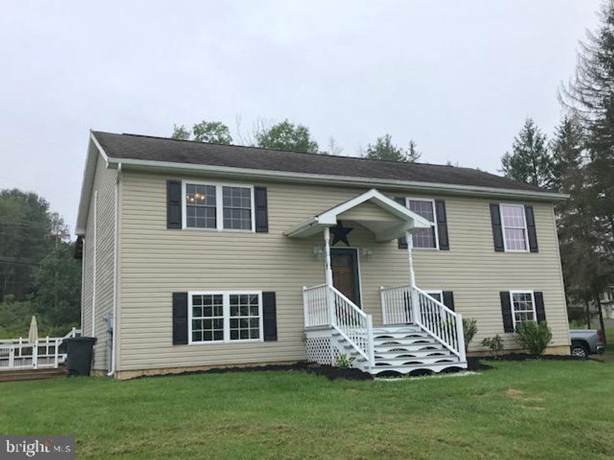 Take notice.....This split level home is move in ready! Offering open floor plan w/cathedral ceilings, 3 bedrooms and 2 baths on the main level. Lower level boasts a large family room, den/office, bath w/garden tub, and bedroom w/dressing area or nursery.    Added features are rear deck, attached carport, porch, above ground pool with decking surround and beautiful railing, on .97 acre.   This one is a must see! Only minutes from Rocky Gap Resort & Casino.