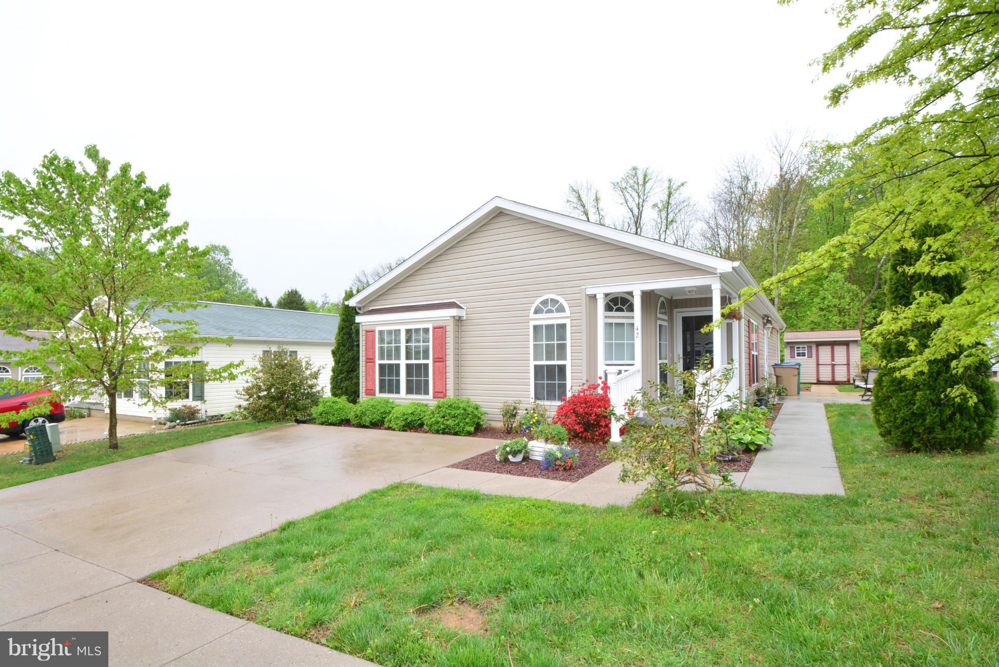 55+ Community. Great 2Bd/2Ba w/den rancher in Cinnamon Woods., Open kitchen with island. Abundance of cabinets & counter space, sep laundry rm, Trad yet open layout w/DR & LR. Front Patio. Home sits on a Crawl Space. 2 car concrete parking pad. Shed in rear. Ground rent includes Lawn mowing, Trash pickup & Snow removal. Buyer must get pre-approved by the community office.
