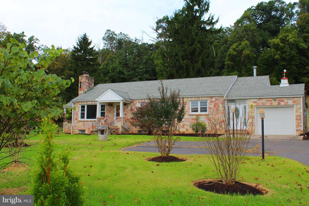 Stone Rancher situated on 9.8 Acres with pond and Wind Mill, borders Cacapon State Park, 3 Bedrooms two Full baths ready for your touch, outdoor stone fireplace, breezeway with wood stove, one car garage.