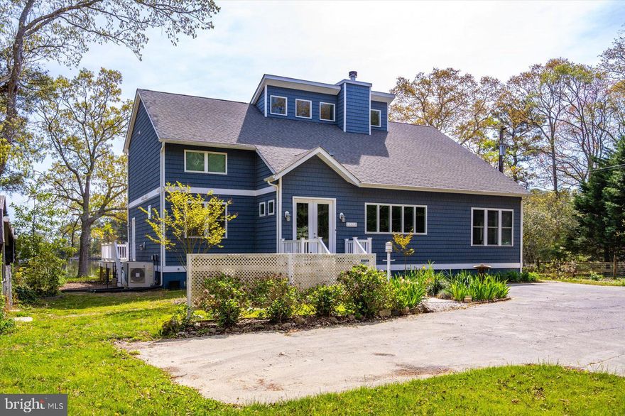 BACK ON THE MARKET! PEACEFUL COUNTRY LIVING WITH SCENIC COASTAL CHARM! HOME OFFERS THE BEST OF BOTH WORLDS! FEEL LIKE YOUR TUCKED AWAY IN THE COUNTRYSIDE, SURROUNDED BY NATURE, AS WELL AS A WATERMANS DREAM LOCATION! CUSTOM WATERFRONT MASTER PIECE ON HERRING CREEK! ONLY MINUTES TO THE COASTAL BEACHES, RESTAURANTS & SHOPPING!  Built in 2022 by Mark Iacona & Fivestar Builders. Welcome to this extraordinary custom-built home, perfectly situated on OVER 111 FEET OF WATERFRONT along the tranquil shores of Herring Creek. This 3-bedroom, 4-bath home with a flexible studio space (ideal as a 4th bedroom or home office) blends thoughtful design, craftsmanship, and sweeping WATER VIEWS IN EVERY ROOM into a one-of-a-kind COASTAL RETREAT. This all-electric home features a NEW PRIVATE WELL with an owned water conditioning system and custom shades throughout, offering comfort, efficiency, and elevated style. At the heart of the home, the chef’s kitchen is a culinary dream—featuring premium finishes, two walk-in pantries, and plenty of space to cook, host, and gather. The main level includes a welcoming foyer, spacious master suite with oversized tiled walk in shower, his-and-her sinks, private water closet, and gorgeous creek views. An open-concept living room with a wood-burning fireplace flows into a bright sunroom surrounded by windows that frame the serene landscape. Upstairs, two additional bedrooms, two full bathrooms, and a generous studio offer versatile space for guests or hobbies—all with abundant storage and more stunning water views. Step outside to a beautifully designed outdoor deck that’s perfect for entertaining or relaxing. Three electric awnings provide shade from the midday sun, creating a cool and comfortable space to enjoy your waterfront surroundings. The property boasts OVER 111 feet of newly bulkheaded water frontage, ideal for launching kayaks, canoes, personal watercraft (PWC), a skiff, or a pontoon boat. Whether you're boating, fishing, crabbing, or simply soaking in the views, this home delivers the ultimate waterfront lifestyle. Located on a quiet and scenic stretch of Herring Creek, this custom residence offers privacy, and seamless indoor-outdoor living. Access the property by a freshly paved private road & driveway! Schedule your showing today and discover this exceptional coastal gem!