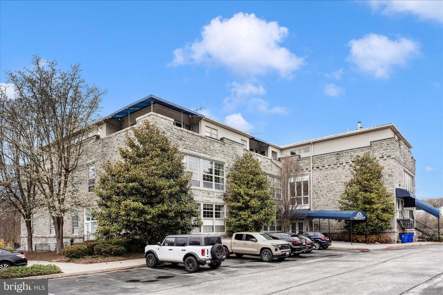 Modern industrial style meets cozy charm in this distinctive Historic Ellicott City condo. 
High ceilings, oversized paneled windows, and abundant natural light showcase treetop and cathedral views. The open-concept living area features a gas fireplace and striking architectural details, while the sleek kitchen is perfect for entertaining or quiet nights in. A spacious primary suite, a second bedroom and half bath provide flexibility for guests, a home office, or additional living space. 
Just steps from Main Street shops, restaurants, the Farmer’s Market, Trolley Trail, and local festivals, this home blends historic character with modern convenience.