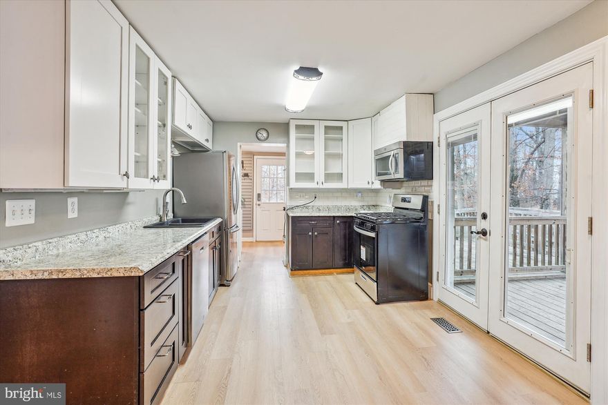 Charming cottage featuring an open floor plan and a gourmet kitchen with brand-new appliances. The main level boasts two inviting bedrooms and a full bathroom, while the upper-level loft offers a separate den, study, or guest room—perfect for versatile living. Nestled on a private lot, the home includes a fenced yard, a spacious deck, and a screened-in porch for year-round enjoyment. Conveniently located near Quantico Base, with easy access to I-95, the VRE, and Amtrak, this serene retreat offers the perfect blend of privacy and accessibility.