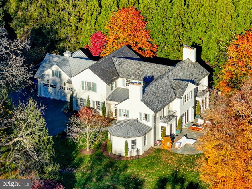 Set along the coveted Falls Road corridor, this exceptional 5+ bedroom, 4.5 bath Charleston Colonial offers a rare blend of architectural pedigree, refined updates, and serene natural beauty—all just moments from Green Spring Station with effortless access to I-83 and I-695. Originally designed by renowned architect Charles Nes and thoughtfully reimagined by Vince Greene Architects, the home has been expanded and renovated to suit today’s modern lifestyle while preserving its timeless character.

Privately sited on over six acres of picturesque land, the property offers a truly private, park-like setting with sweeping vistas—delivering a seamless balance of tranquility and convenience. Inside, sophisticated yet inviting living spaces unfold throughout, highlighted by a beautifully updated gourmet chef’s kitchen with adjoining scullery, flowing effortlessly into a warm and welcoming family room with fireplace—one of four throughout the home. A richly appointed wood-paneled library with custom built-ins provides an ideal retreat for work or relaxation, while a spacious laundry room and kids playroom completes the main level.

The primary suite serves as a true sanctuary, featuring a renovated bath, expanded closet space, in-suite laundry, and a peaceful private balcony overlooking the surrounding landscape. A versatile second-floor bonus room offers flexibility as a playroom, office, or additional lounge space. Four additional bedrooms and three full baths complete the upper level, providing ample space for family and guests alike.

Outdoor living is equally compelling, with a wraparound bluestone patio, dedicated grilling and dining areas, and six acres of uninterrupted natural beauty—perfect for both quiet enjoyment and entertaining. This is a rare opportunity to own a thoughtfully curated estate where timeless architecture, modern luxury, and an exceptional location converge.