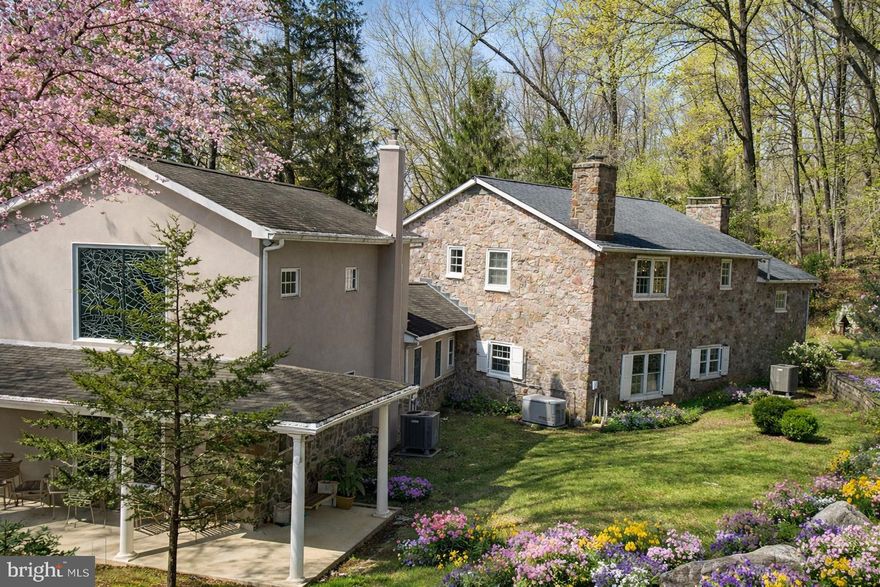 Tucked behind Spring Mountain Ski Area and bordered entirely by the scenic Perkiomen Creek, this remarkable 23-acre gated property offers a rare opportunity to own a truly private retreat in the heart of Montgomery County.

A winding drive leads through stately gates and into a serene landscape of mature trees, open grounds, and peaceful creekside vistas. With water wrapping the property, every corner feels connected to nature—creating an unparalleled sense of privacy and escape just a short drive from the Main Line and Philadelphia.

The main residence blends timeless character with warm, inviting spaces. Sunlit interiors feature hardwood flooring, exposed beams, and multiple gathering areas designed for both everyday living and entertaining. Expansive windows frame views of the surrounding landscape, bringing the outdoors in throughout the seasons.

The property is uniquely equipped as a private compound, offering multiple structures that provide flexibility for a variety of lifestyles. A detached guest residence with a two-car garage presents an ideal opportunity for extended family, an au pair suite, or creative renovation. A charming log cabin adds additional character—perfect as a studio, workshop, or quiet retreat space.

Outdoors, the property becomes the true centerpiece. Gently rolling grounds, wooded areas, and open clearings offer endless possibilities—from recreation and relaxation to hosting unforgettable gatherings. The creekside setting, with its natural beauty and tranquil sound of flowing water, creates an atmosphere that is both peaceful and inspiring.

Preserved under Pennsylvania’s Clean & Green program, the property benefits from significantly reduced taxes while maintaining its natural beauty and open space.

Whether envisioned as a private estate, a weekend retreat, or a multi-generational compound, this one-of-a-kind property offers a lifestyle rarely found in the region—where land, water, and privacy come together in perfect harmony.