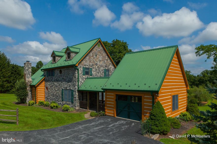 A fabulous log/ stone contemporary. Estate setting. Mountain Views. Sited on 16+- ac about 3 miles from Berkeley Springs  Elegant and rustic w/ a pond/dock + separate Sleepy Creek frontage. Bass Stream!( DNR designates as high quality sport fishing stream. Hardwood floors. Highest quality Post and Beam construction-log, stone and metal roof. Pro landscaping. Immaculately maintained.Great family room with vaulted wood ceiling,stone fireplace. Big rear deck. Porch. 2nd well for pond! Peaceful. Private. Breezeway to oversized garage.