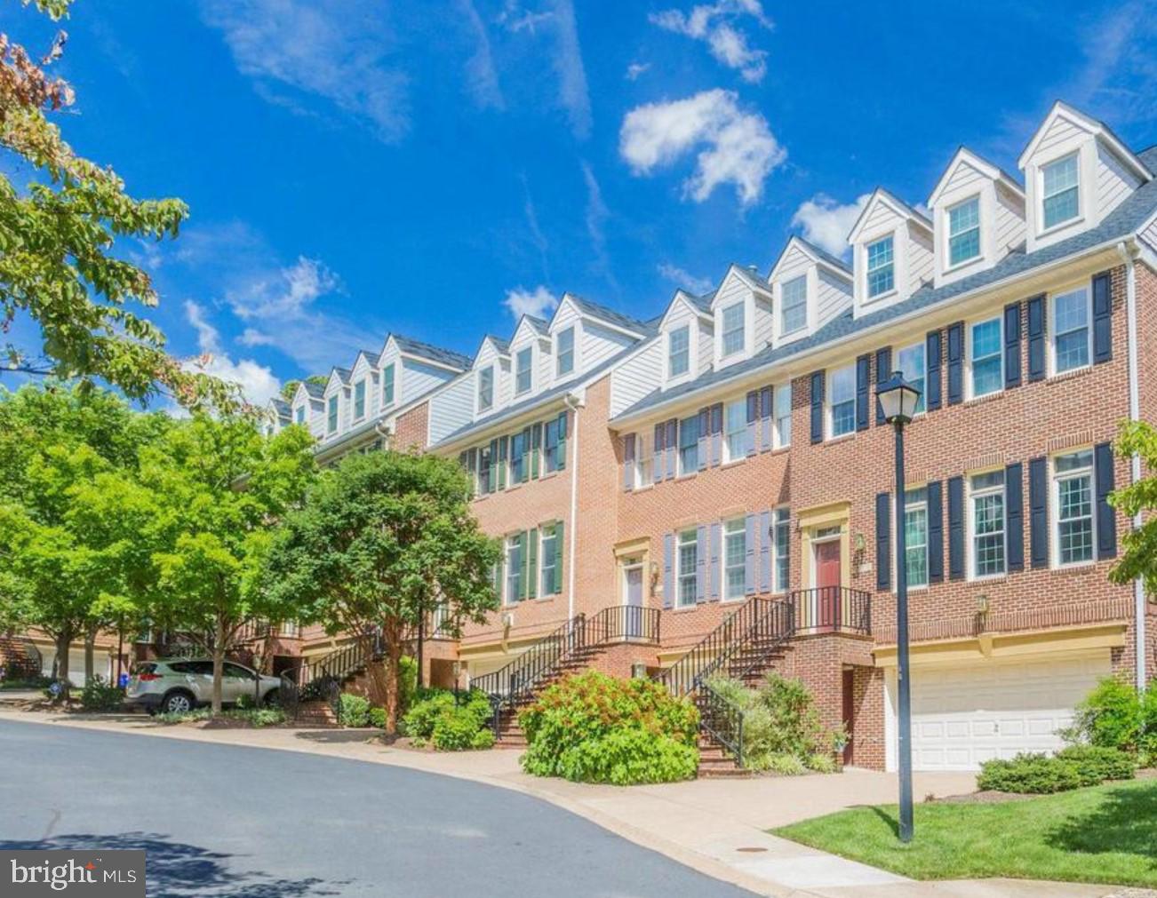 Welcome to 2119 21st Rd. N., located in the coveted North Arlington. This stunning property sits in Hillcrest, one of North Arlington's most prestigious luxury townhome communities. A boutique enclave of just 33 townhomes spread across seven pristine acres, Hillcrest is nestled on a scenic hill above Spout Run Parkway and the Potomac River. Surrounded by protected National Park Service lands, this secure and private community offers peace and exclusivity. Situated on an exceptional lot within the development, this home enjoys an expansive, open setting that fosters a sense of calm and spaciousness. Blending the timeless elegance of colonial architecture with the convenience of modern design, the home strikes the perfect balance between old-world charm and contemporary comfort.
This extraordinary four-level townhome offers 3800 square feet of beautifully designed living space. With four bedrooms, three full bathrooms, and two half bathrooms, this home blends timeless elegance with meticulous attention to detail. Rich trim work and soaring ceilings bring an air of sophistication to every room.
Enter into the main level, with a traditional floor plan. The living room with large windows, built in shelving, a double sided gas fireplace is open to the dining room yet remains cozy and private. The dining room shares the double sided fireplace, features a chandelier and columns. The kitchen is an entertainer’s dream, with an enlarged kitchen counters with striking granite countertops and seating around two sides of the island for 6+. There is also a cozy window seat with views of the backyard! Sliding doors open to a spacious terrace, ideal for al fresco dining or simply relaxing outdoors. Stairs down to the basement are located at the rear of the home. The custom artwork in the stairwell can convey upon request.
Upstairs, the luxurious primary suite and one junior suite share the third level. The primary suite, located in the rear of the home, features generous closet space, and is bathed in natural light from windows and has a peninsula gas fireplace between the sitting area and main bedroom. The en-suite bathroom includes a glass-enclosed shower, dual vanity sinks, and a soaking tub. The junior suite faces the front of the home has a private bathroom with shower/tub. For convenience, the laundry is located on this level.
The fourth level offers a unique retreat, with a retractable screen splitting the space into two rooms sharing a full bathroom. The part of the room on the front of the home has attic storage access, the larger room on the rear of the home has 3 dormer windows an sitting room space. Together they create a usable, convertible space to accommodate guests or just to have additional privacy and space with the custom power screen.
The lower level has a large rec room with built in storage, a powder room, and access to the oversized two car garage. The garage has two storage areas, one open on the side, and one secured with a door. The white fridge in the closed storage room conveys.