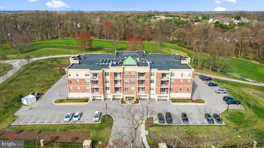 Deluxe 2 bedroom and 2 bath corner penthouse residence in the contemporary condominiums offering many valued amenities including a deeded oversized private garage, in sought-after Vantage at Turf Valley. A bright open home welcomes you inside a secure entry elevator building, and a vivid home featuring EnergyStar windows, statement lighting, neutral carpeting, refined profile crown molding, a laundry closet with washer and dryer, over 1,439 sqft, an easy lifestyle, and a private balcony overlooking the golf course. Invited inside by a warm hardwood foyer, you find an open dining room, a gourmet kitchen boasting a double pantry, granite counters, 42" espresso Shaker cabinetry with under cabinet lighting, subway tile backsplash, sleek stainless steel appliances, and an island with a breakfast bar highlighted by pendant lighting overlooking the main living areas creating the perfect social and entertainment hub. Plentiful natural light brightens the living room  showing double windows and glass slider access to a low maintenance balcony with a view. Owner's suite presents a large customized walk-in closet, a breezy ceiling fan, and a personal bath with ceramic tile flooring, a double vanity, and a double shower. An ideal location close to Turf Valley's Towne Square, shopping, dining, golf courses, and easy access to commuter routes and BWI airport.