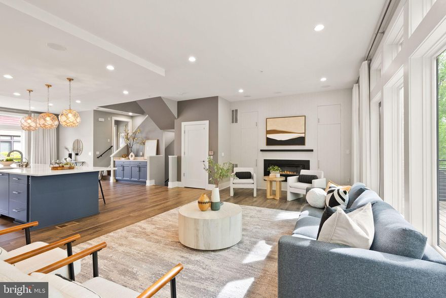 Elevator living at its best! Welcome home to the pinnacle of luxury living at Grosvenor Heights! This upgraded Harrison Model is among the most exceptional residences in Grosvenor Heights, offering more than 3,100 square feet of refined living space across four levels. Every detail has been curated to deliver the ultimate in luxury, technology, and design.

On the entry level, a wide foyer welcomes you into a versatile bedroom suite with full bath, a custom mudroom with built-ins, and direct access to the two-car garage. From here, step into the private, cedar-fenced backyard lined with vibrant, year-round turf and framed by wooded views.

Head up to the main level which is defined by soaring 10-foot ceilings, wide-plank floors, and walls of windows that flood the space with natural light. The gourmet kitchen features an oversized quartz island, paneled Sub-Zero refrigerator, Thermador cooking suite, Bosch dishwasher, and a striking marble herringbone backsplash. A dedicated coffee bar and abundant pull-out pantry storage enhance both function and elegance. The living room showcases a sleek gas fireplace surrounded by bespoke built-ins, while in-ceiling Bowers & Wilkins speakers pair with the fully integrated Savant home automation system for a seamless audio and video experience throughout every TV and speaker in the home. Extending the living space outdoors, a large balcony with gas line for a grill easily accommodates a dining table and chairs and overlooks serene treetop views.

Upstairs, the bedroom level offers a tranquil Owner’s Suite with custom closets featuring stunning built-ins, a spa-inspired bath with dual vanities and frameless glass shower, and peaceful wooded views. Two additional bedrooms, a full bath with tub, and a convenient laundry room complete this level.

The rooftop terrace crowns the home with the ultimate outdoor retreat—boasting a retractable awning, outdoor speakers, mounted TV, refrigerator, and wet bar—perfect for both large gatherings and private evenings under the stars.

Additional luxuries include a private elevator to all four levels, a modern open-riser staircase with metal railings, multiple indoor-outdoor spaces, and thoughtful upgrades throughout.

Perfectly sited on one of the most desirable rows backing to trees, this residence represents the pinnacle of Grosvenor Heights living—offering unmatched privacy, refined style, and effortless convenience, just minutes from Metro, Wildwood Shopping Center, downtown Bethesda, and major commuter routes.