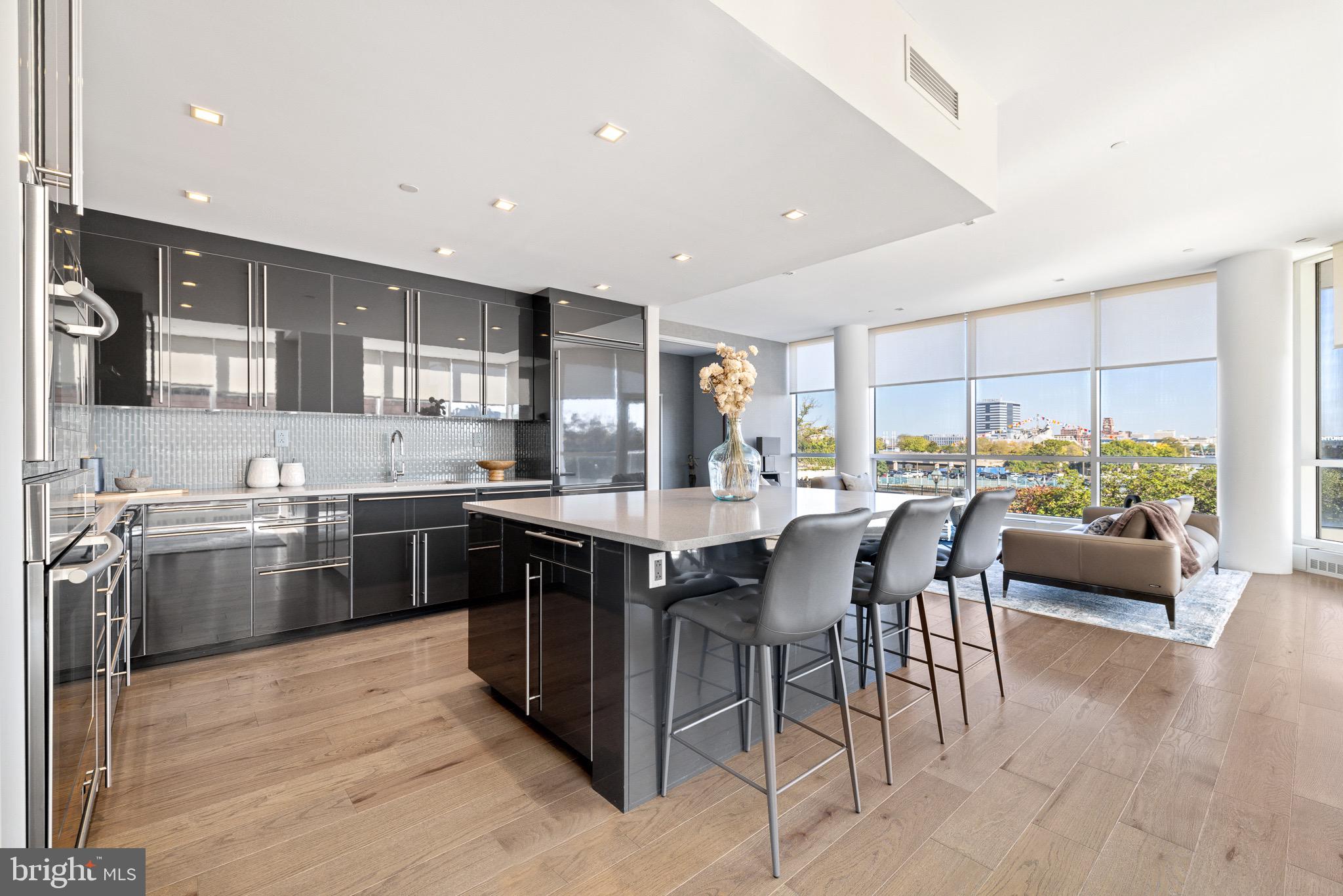 101 Walnut Street represents the epitome of elegance and exclusivity in Society Hill, Philadelphia. This thoughtfully designed 2,423-square-foot condo boasts two bedrooms, two full bathrooms, a powder room, and two sprawling terraces that encompass approximately 1,000 square feet of outdoor living space.
As you enter the condominium building, you are immediately welcomed by luxurious features such as an exclusive key-access elevator that takes you directly from the lobby to your front door, ensuring a secure and private entrance.
Upon entering through the double doors into the unit, prepare to be amazed by the abundance of natural light, courtesy of the floor-to-ceiling windows and 10ft ceilings. The warmth is complemented by the scenic views of the Delaware River and the picturesque tree-lined block.
The open layout has been thoughtfully customized, making it a one-of-a-kind in the building; the home has been designed to maximize every inch of this unit's available space. The enormous living space gracefully flows into the dining area which leads to your first outdoor terrace. Make your way into the Poggenpohl designer kitchen that features Miele appliances, an enlarged Silestone waterfall-style island, and a breakfast bar. To add, the kitchen displays a custom glass backsplash, Silestone countertops, a wine refrigerator, and ample custom cabinetry.
Proceed into the supplementary den, ideal for relaxation or expanding your entertainment space. The den provides additional built-in cabinetry and a newly installed fireplace.
The oversized primary suite showcases sophistication and serenity, displaying a tasteful contemporary design. You will be pleased to find walk-in closets that surpass an ideal amount of storage space. Details such as the marble fireplace and heightened ceilings will not go unnoticed. Adding on, enjoy the luxury of the spa-like primary bathroom which provides a soaking tub, tile flooring, a glass-enclosed standing shower, and a dual vanity sink.
At the rear of the unit, the western-facing 900-square-foot terrace stands as the crowning jewel, accentuated by soothing water features, creating a retreat-style ambiance. The terrace provides a perfect environment for entertaining or enjoying your morning coffee in the tranquility of what feels like a backyard in the city. To add, the terrace is conveniently equipped with an irrigation system to keep your outdoor greenery fresh. Finally, indulge in the luxury of a single parking space included in the securely gated attached lot.
101 Walnut Street stands as a testament to the ultimate lifestyle of a peaceful, private, and elegant way of living, hidden away in one of Society Hill's most coveted addresses. Arrange your tour today to partake in this exceptional opportunity and transform 101 Walnut Street into your new residence.