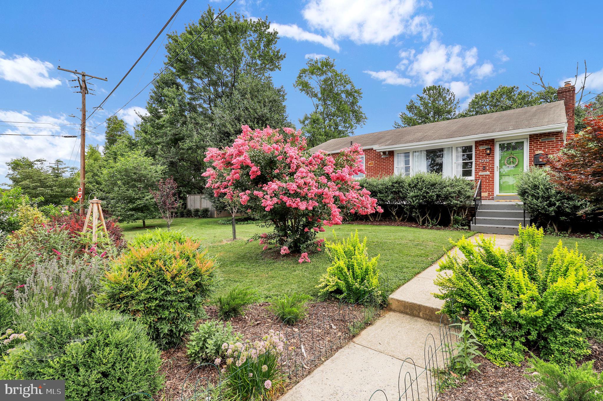 Welcome to 1215 Kirklynn Avenue, a beautifully updated home in the heart of vibrant Takoma Park—where classic architecture meets modern comfort and a lush garden sanctuary surrounds you with nature. This one-of-a-kind home blends timeless character with thoughtful upgrades, offering indoor-outdoor living in a peaceful, community-centered setting.
Begin your mornings on the west-facing front porch or unwind in the private, fully fenced backyard—both perfect spots to relax and take in the natural beauty that defines this property. Inside, the main level features refinished hardwood floors, two light-filled bedrooms and a third bedroom being used as a dining room, and an updated full bath. The inviting living room flows into a dedicated dining area and leads to a beautifully remodeled kitchen that opens directly to the backyard, creating an ideal layout for everyday living and entertaining.
The kitchen strikes the perfect balance between style and function, featuring sleek stainless steel appliances with gas cooking and a charming breakfast nook that invites lingering over morning coffee and conversation.
The fully finished lower level expands the home’s flexibility and comfort, offering a recreation room, two bonus rooms, a full bath, laundry, and utility space. With its private entrance, this level is ideal for multigenerational living, a guest suite, or creative studio space.
Major updates include a new water heater (2025), a central HVAC system approximately 10 years old, and a newly installed central AC. Fresh paint throughout enhances every room, and a large shed plus off-street parking in the driveway add everyday convenience.
The professionally landscaped yard is a true gardener’s paradise. Over 100 native and perennial plants have been lovingly added by the current owners, creating a certified butterfly and native plant garden that supports a thriving ecosystem of butterflies, birds, and squirrels. This drought- and deer-resistant landscape features perennial lavender, fig and persimmon trees, Japanese cherry and maple trees, and colorful blooms through three seasons.
Sustainability is at the heart of this home’s story. Ideally located just steps from the Takoma Park Community Center, Sligo Creek Park, and the beloved Takoma Farmers Market, you're also within walking distance to local favorites including the Takoma Co-op, Spring Mill Bakery, Soko Butcher, Cielo Rojo, Azalea Nails, Takoma schools, and the brand-new Takoma Library. The Metro, Old Town gazebo, and downtown Silver Spring are just minutes away, making this home as convenient as it is charming.
1215 Kirklynn Avenue is more than a house—it’s a lifestyle rooted in community, nature, and thoughtful design. Whether you love to garden, host friends, or simply enjoy peaceful moments on the porch, this exceptional home is ready to welcome you.